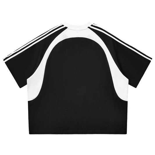 Black and white athletic top with stripes on the sleeve and mesh paneling in front of a white background