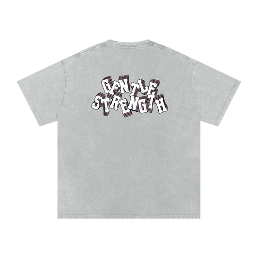 Back of light Gray t-shirt with 'Gentle Strength' text in front of a white background.