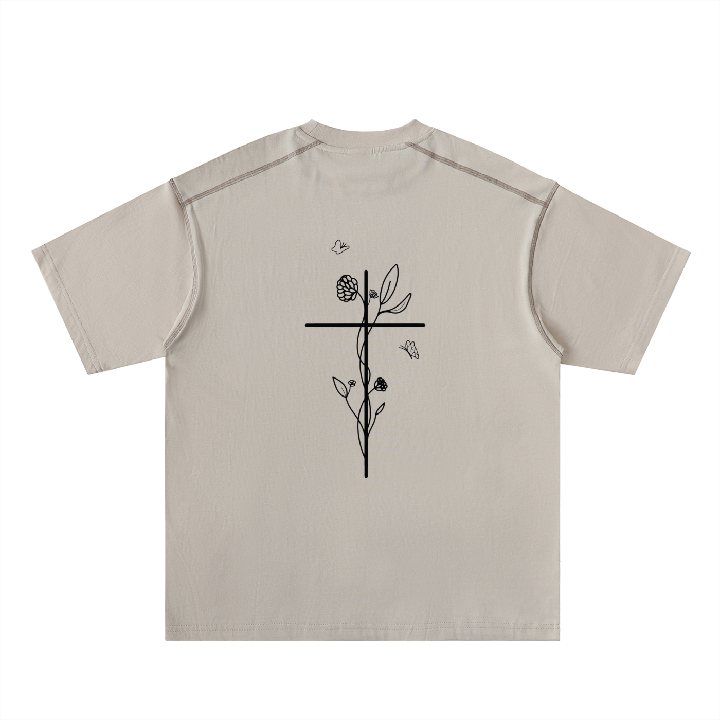 Beige t-shirt with black floral, cross, and butterflies design on a white background