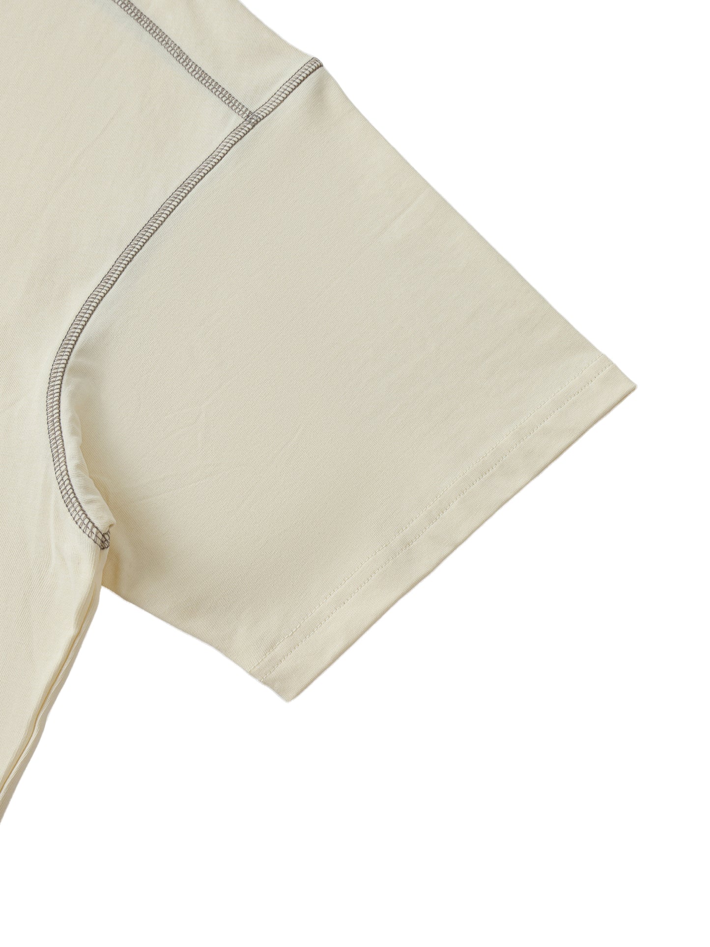 Close-up of beige fabric with a subtle pattern on a white background