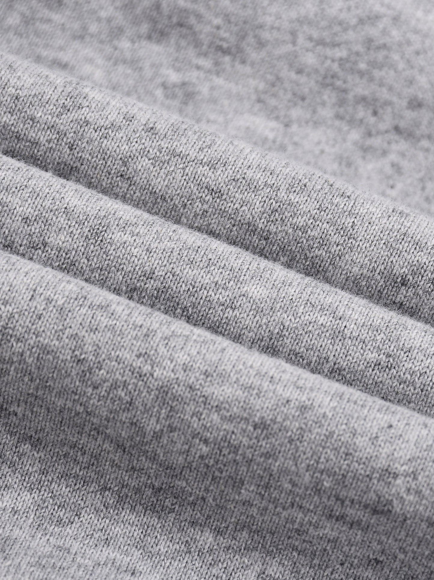 Close-up of gray fabric with a textured pattern in folds