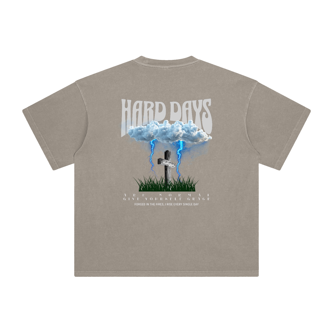 Beige t-shirt with graphic design and text on the back. Graphic design consists of Clouds with lightning, a cross, and some grass graphic. Bold text on the top says "Hard days" and bottom text saying "are normal" "Give yourself grace" "forged in the fires, I rise every single day". 