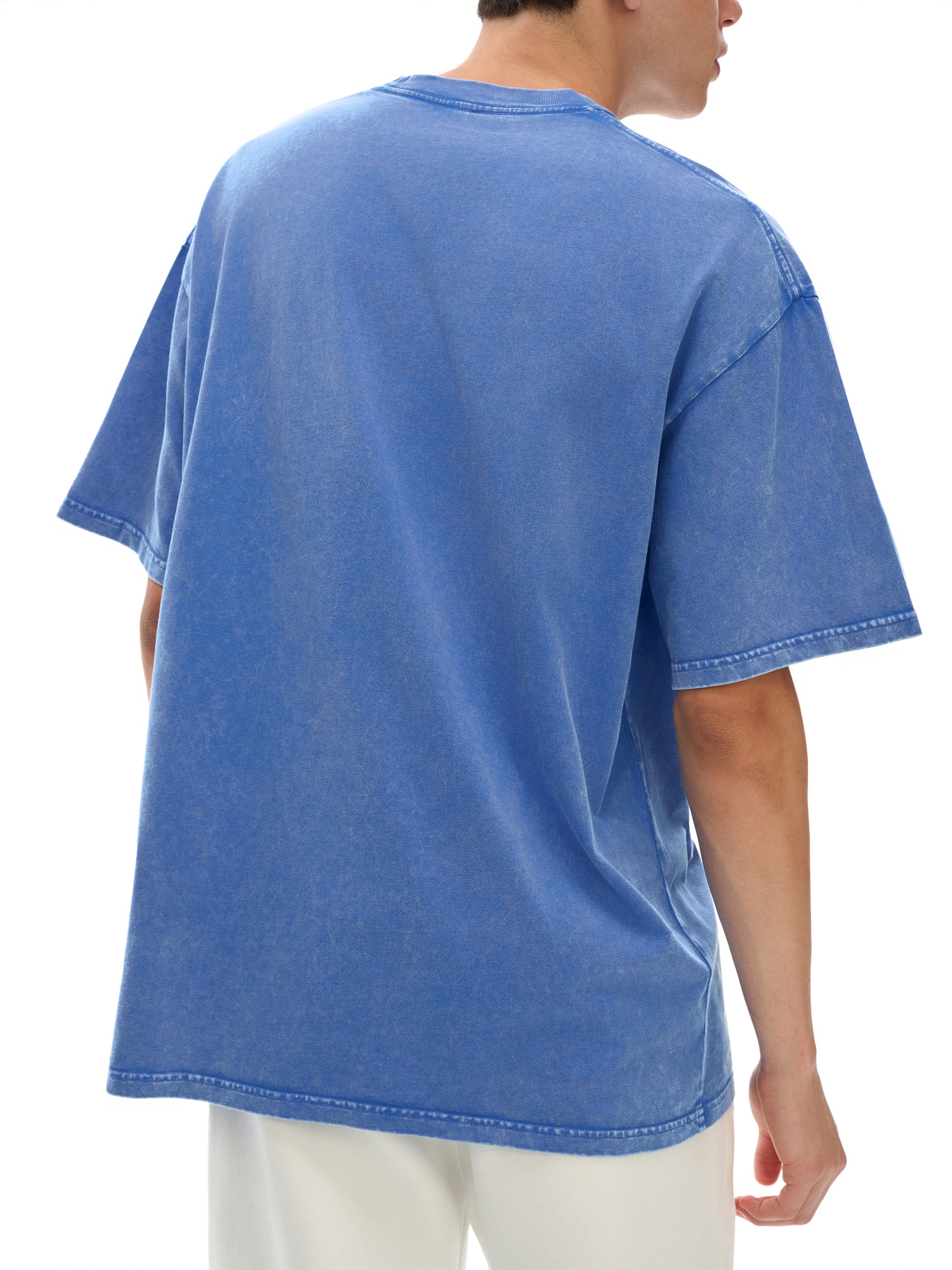 Blue t-shirt worn by a person on a white background