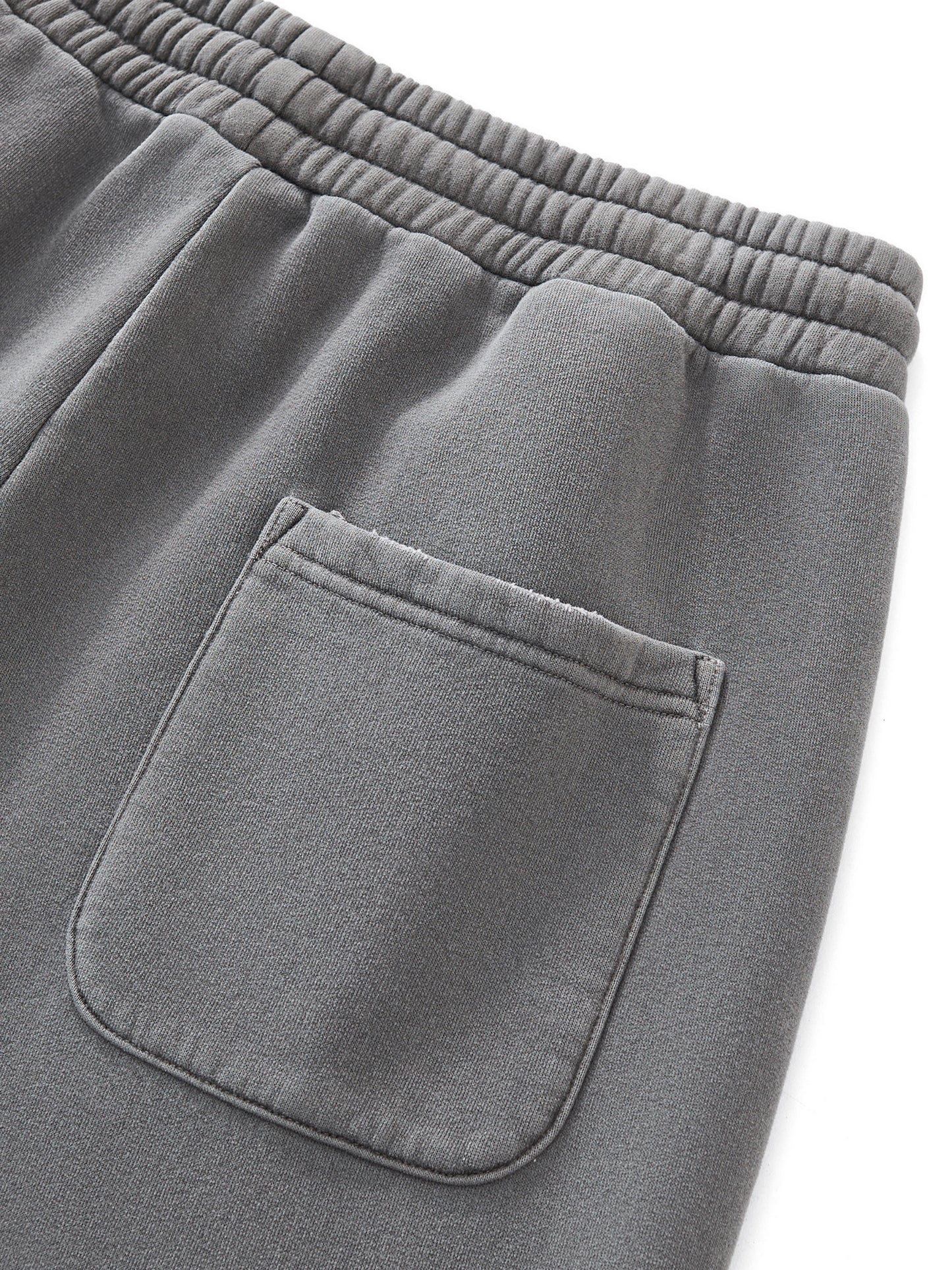 Close-up of gray sweatpants with a pocket on a white background