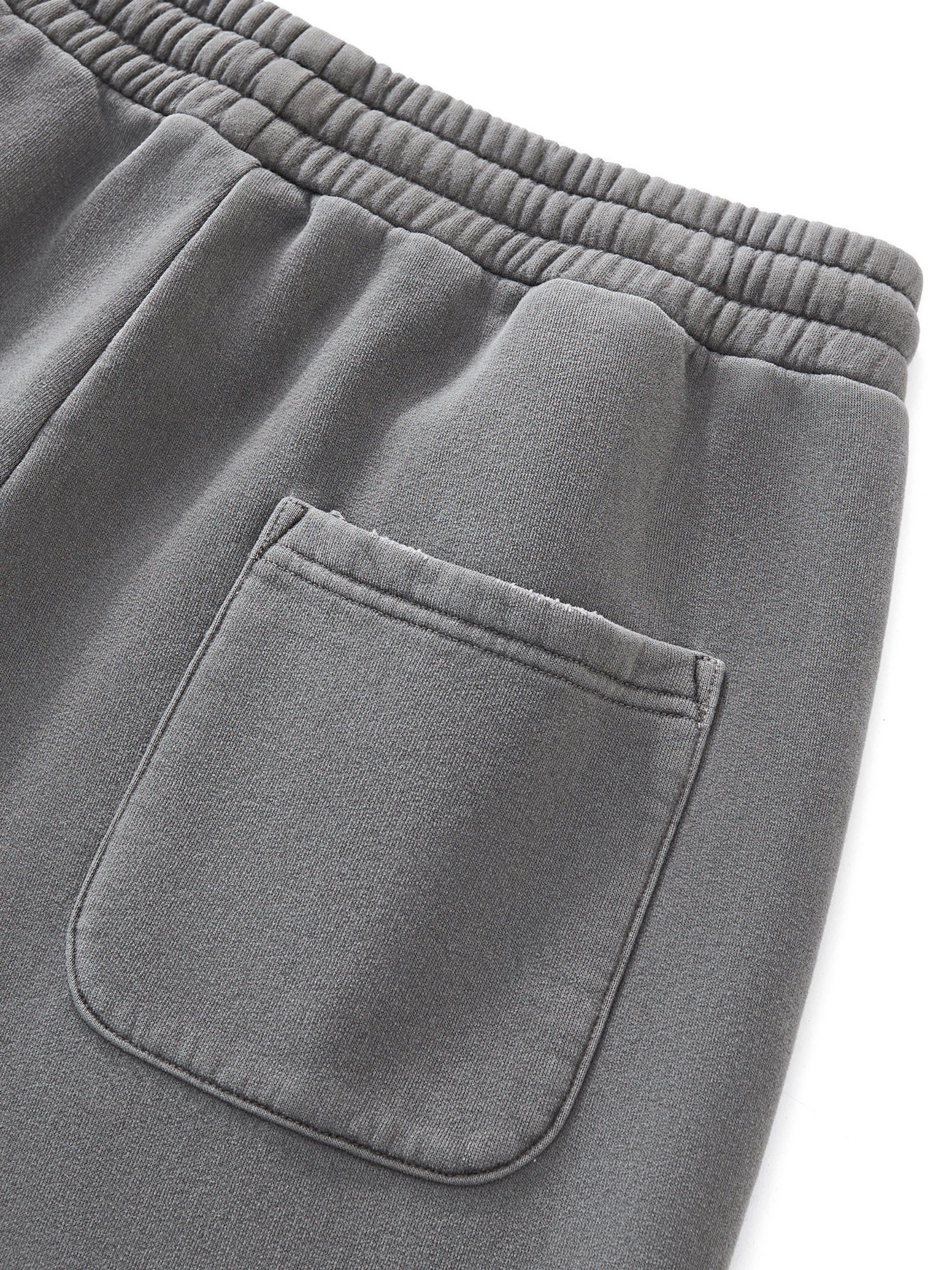 Close-up of gray sweatpants with a pocket on a white background