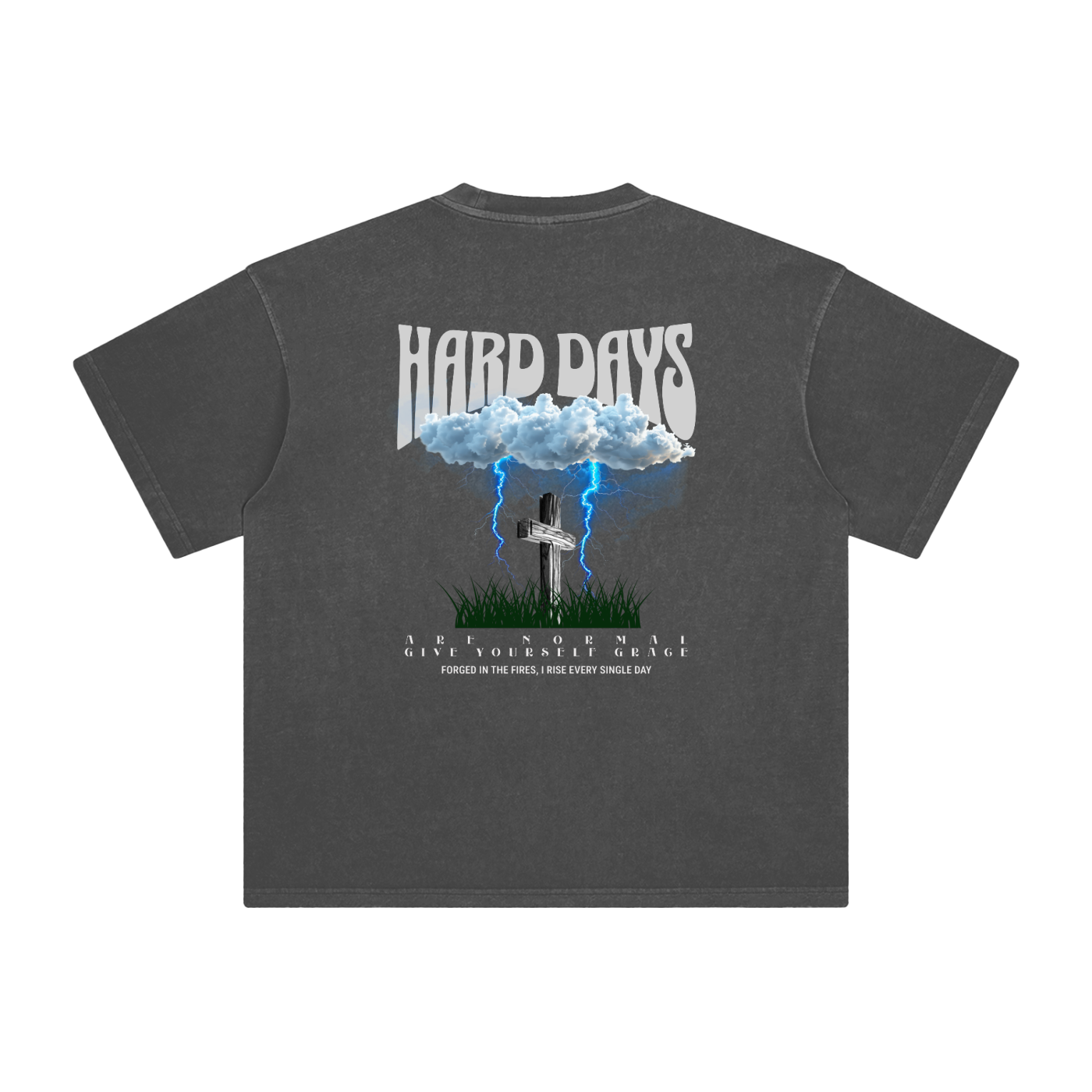 Gray t-shirt with graphic design and text on the back. Graphic design consists of Clouds with lightning, a cross, and some grass graphic. Bold text on the top says "Hard days" and bottom text saying "are normal" "Give yourself grace" "forged in the fires, I rise every single day". 