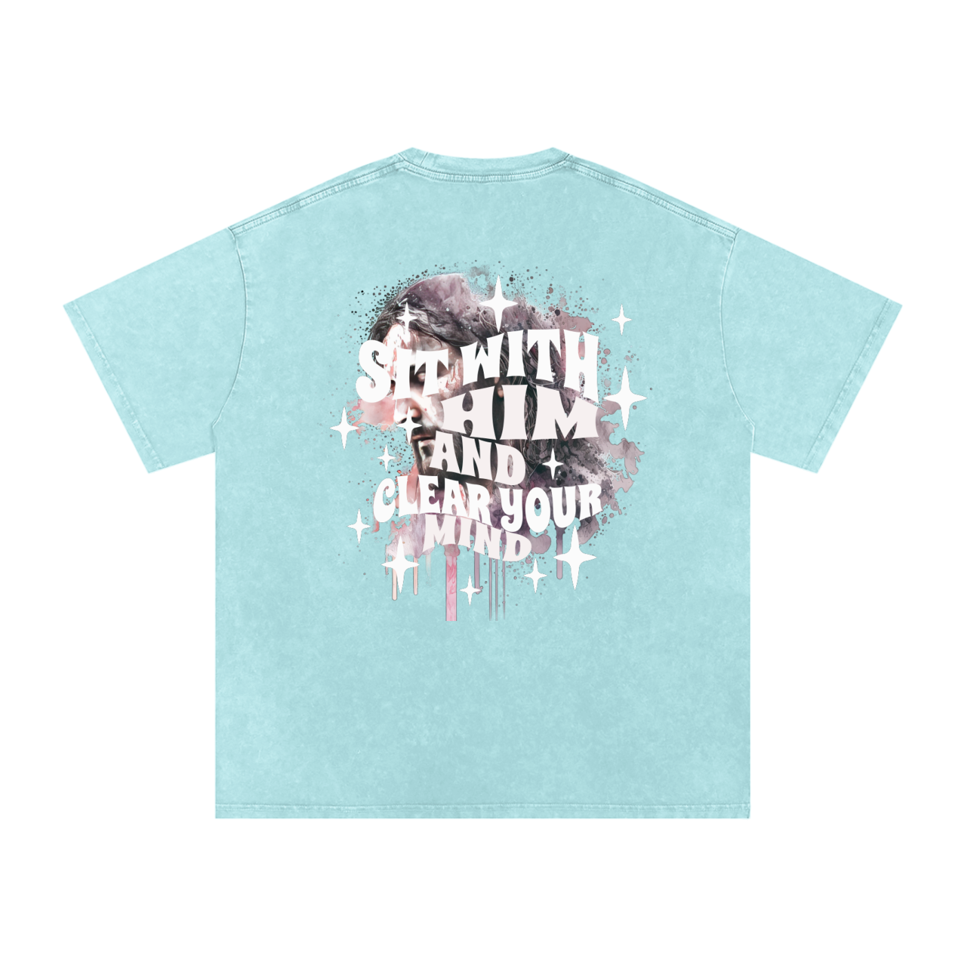 Back of light blue t-shirt with 'sit with him and clear your mind' text, and a graphic watercolor of Jesus in the colors pink, gray, black, white, and purple, with white sparkles scattered around the design, in front of a white background.