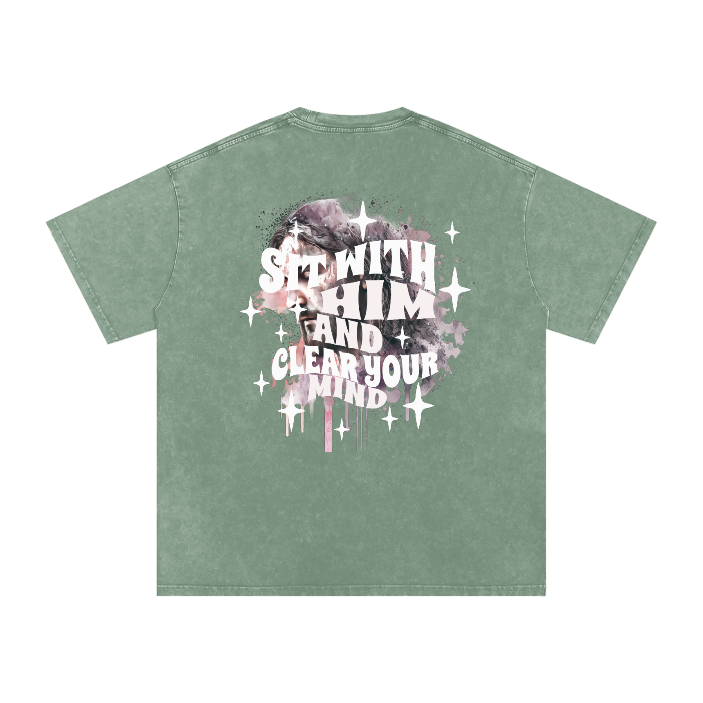 Back of light green t-shirt with 'sit with him and clear your mind' text, and a graphic watercolor of Jesus in the colors pink, gray, black, white, and purple, with white sparkles scattered around the design, in front of a white background.