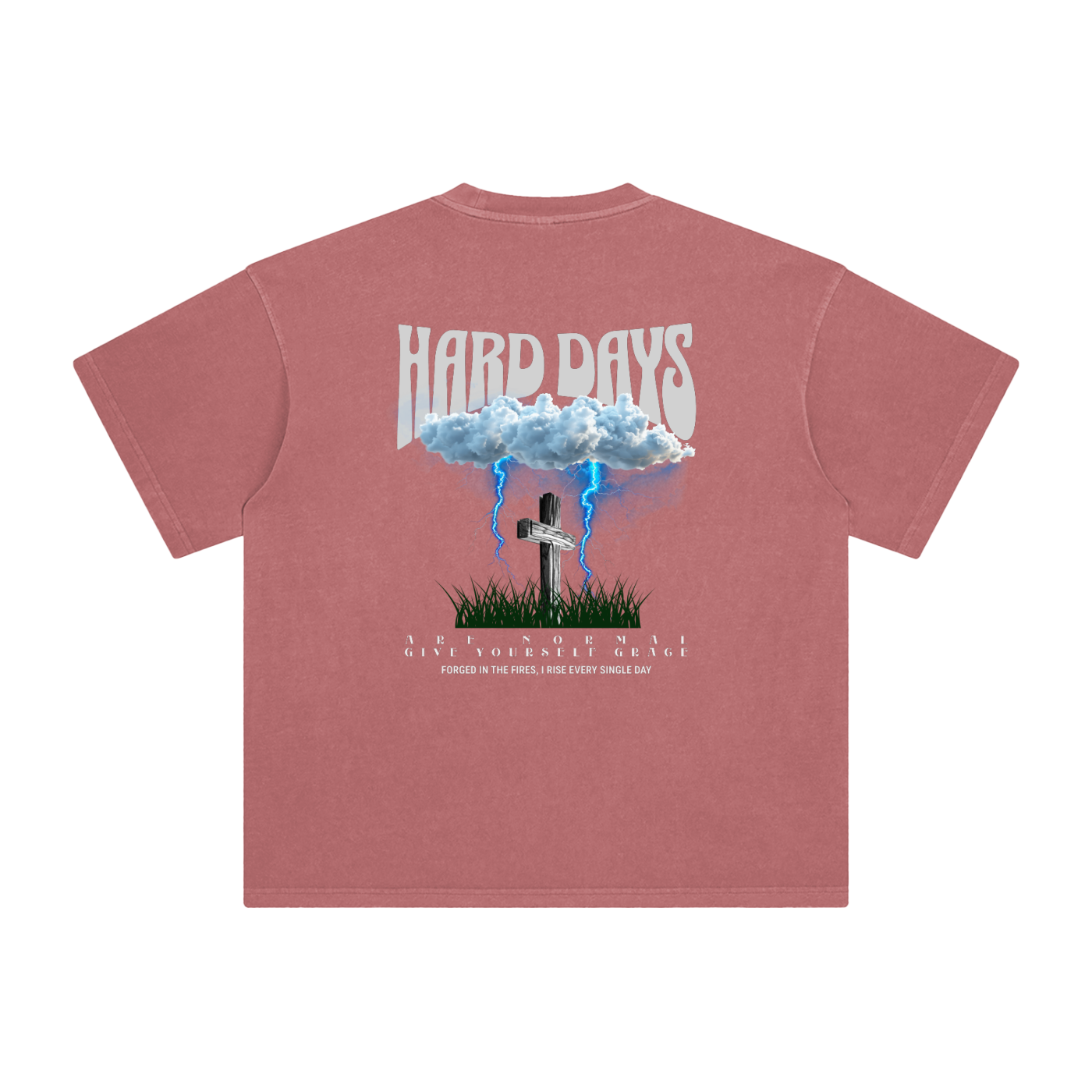 Light Red t-shirt with graphic design and text on the back. Graphic design consists of Clouds with lightning, a cross, and some grass graphic. Bold text on the top says "Hard days" and bottom text saying "are normal" "Give yourself grace" "forged in the fires, I rise every single day". 