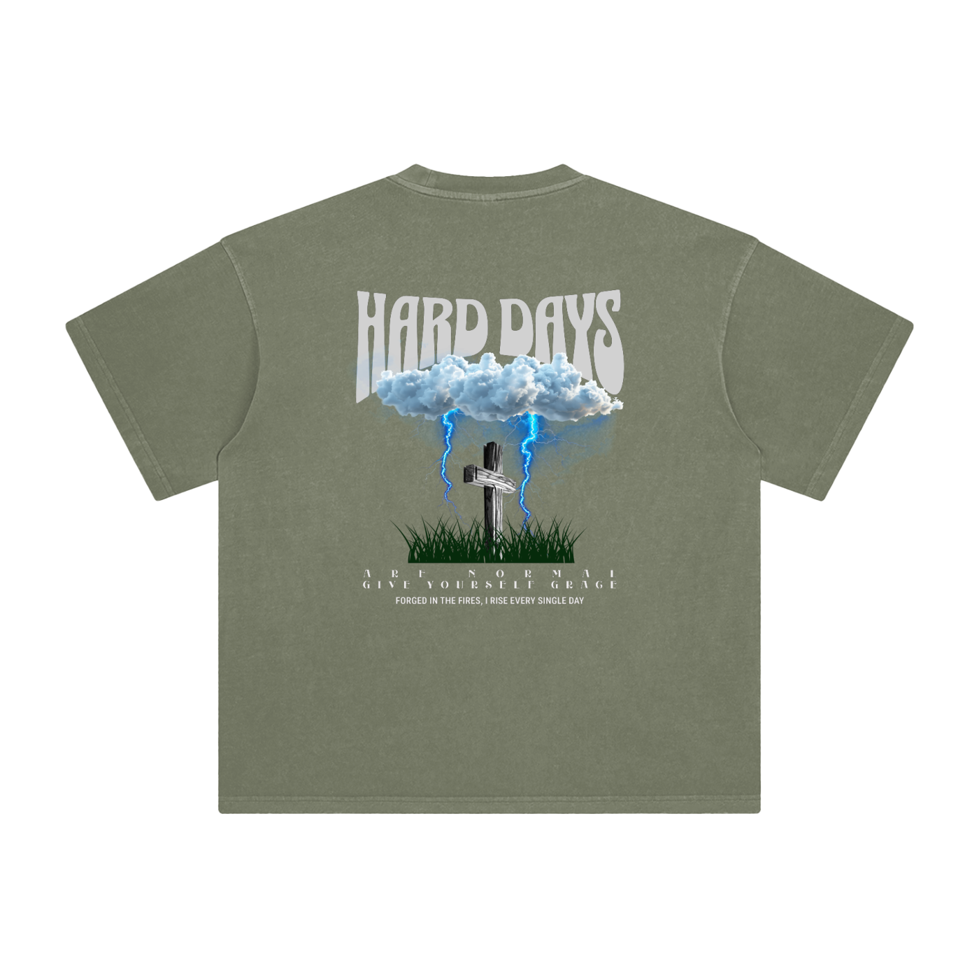 Olive Green  t-shirt with graphic design and text on the back. Graphic design consists of Clouds with lightning, a cross, and some grass graphic. Bold text on the top says "Hard days" and bottom text saying "are normal" "Give yourself grace" "forged in the fires, I rise every single day". 