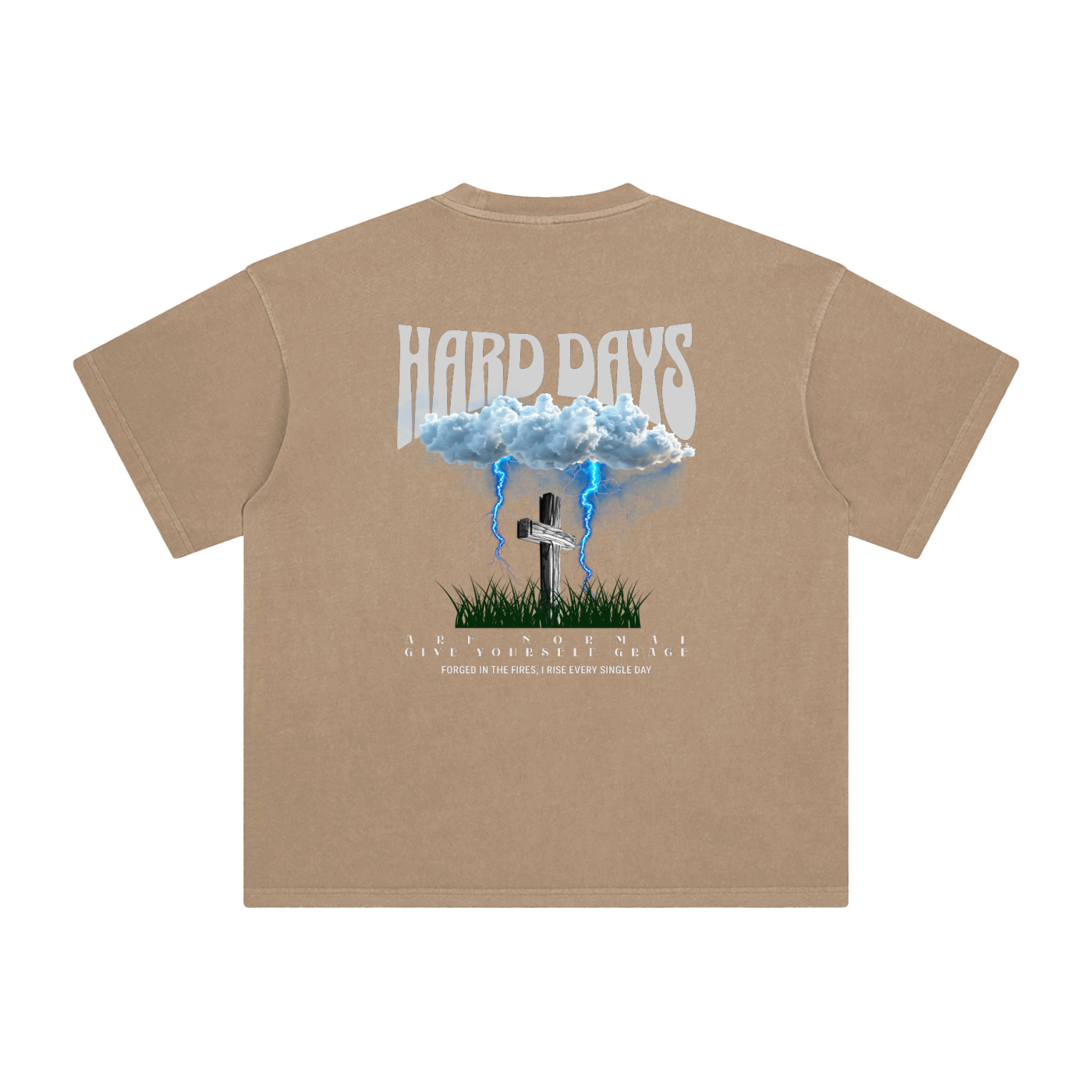 Tan t-shirt with graphic design and text on the back. Graphic design consists of Clouds with lightning, a cross, and some grass graphic. Bold text on the top says "Hard days" and bottom text saying "are normal" "Give yourself grace" "forged in the fires, I rise every single day". 