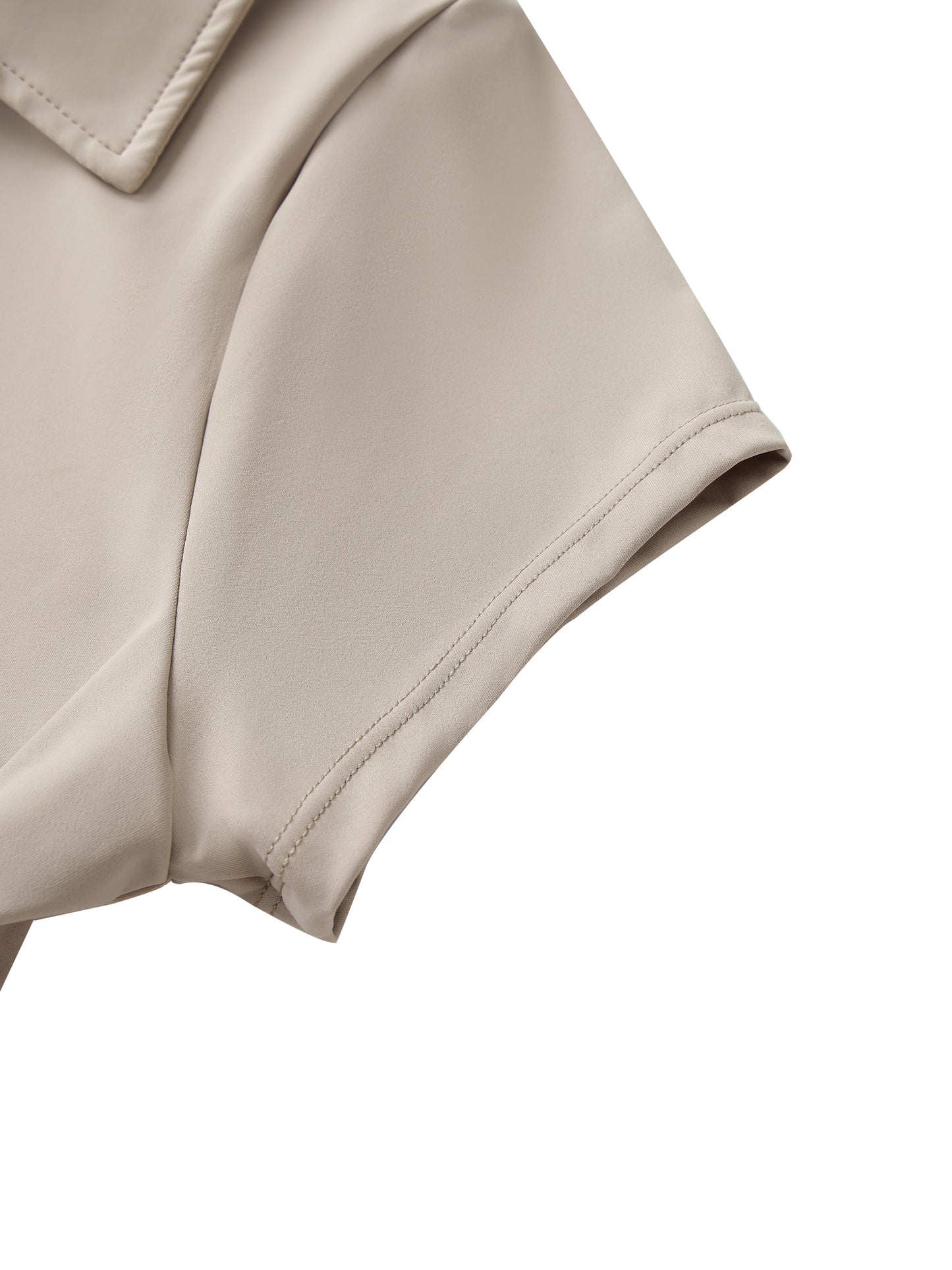 Close-up of a beige cropped top sleeve on a white background