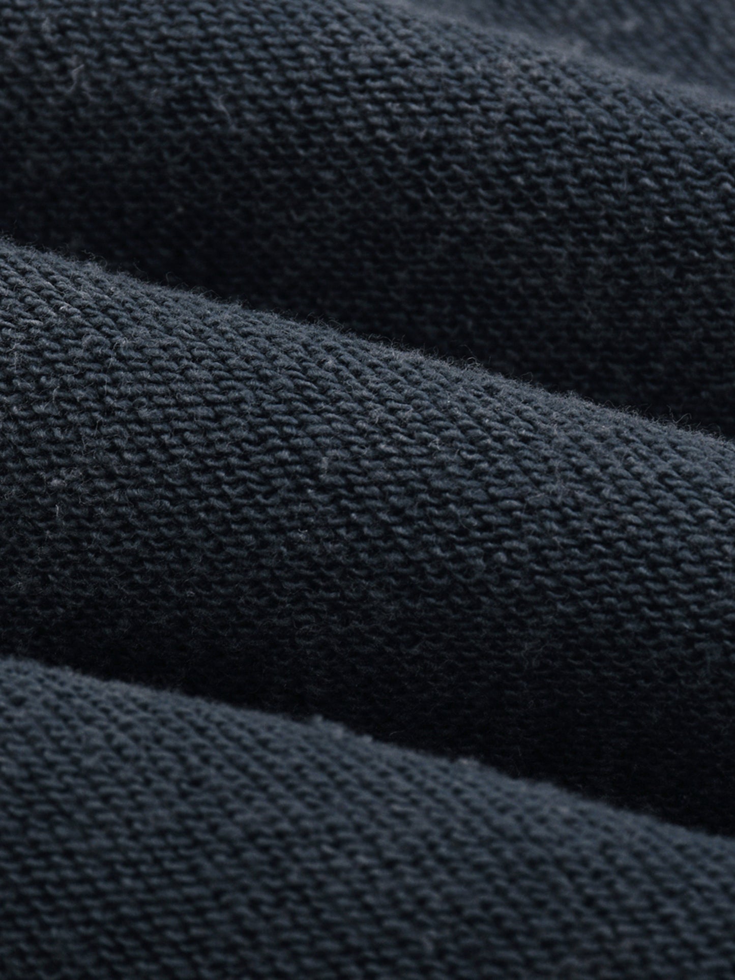 Close-up of dark blue fabric with a textured pattern