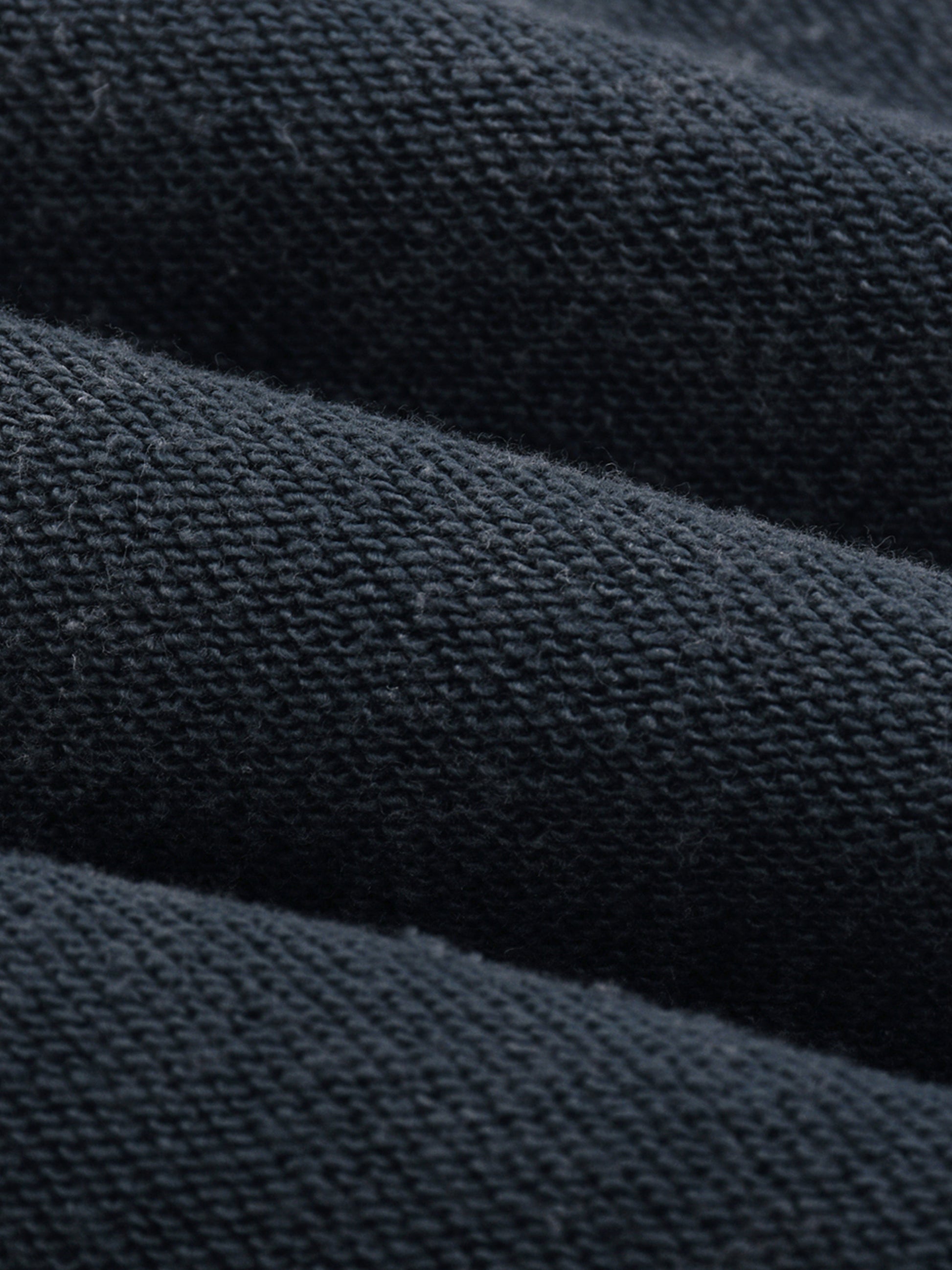 Close-up of dark blue fabric with a textured pattern