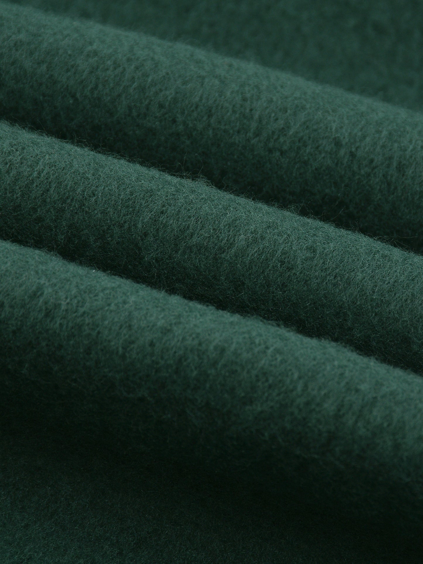Close-up of dark green fabric with visible texture