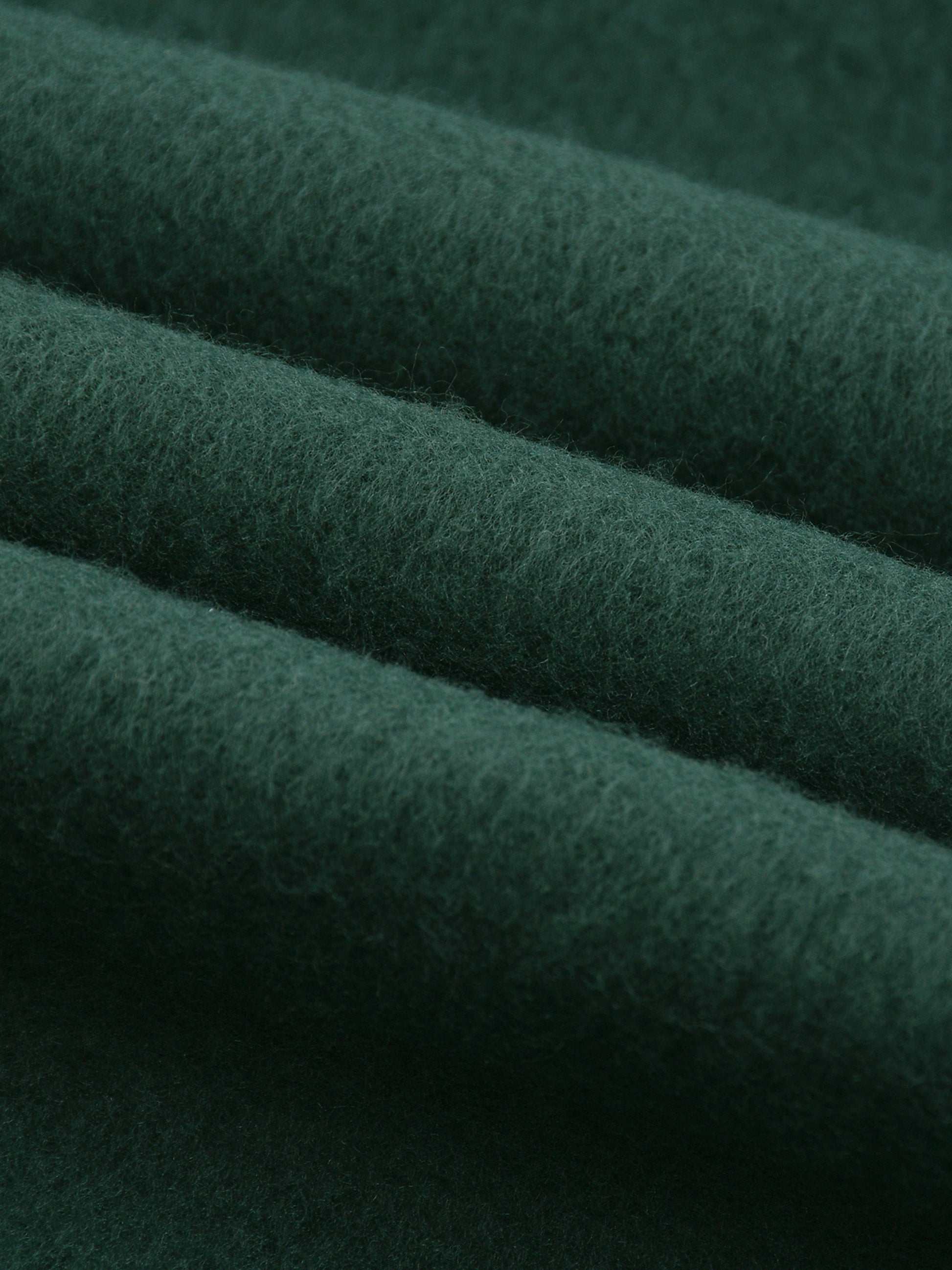 Close-up of dark green fabric with visible texture