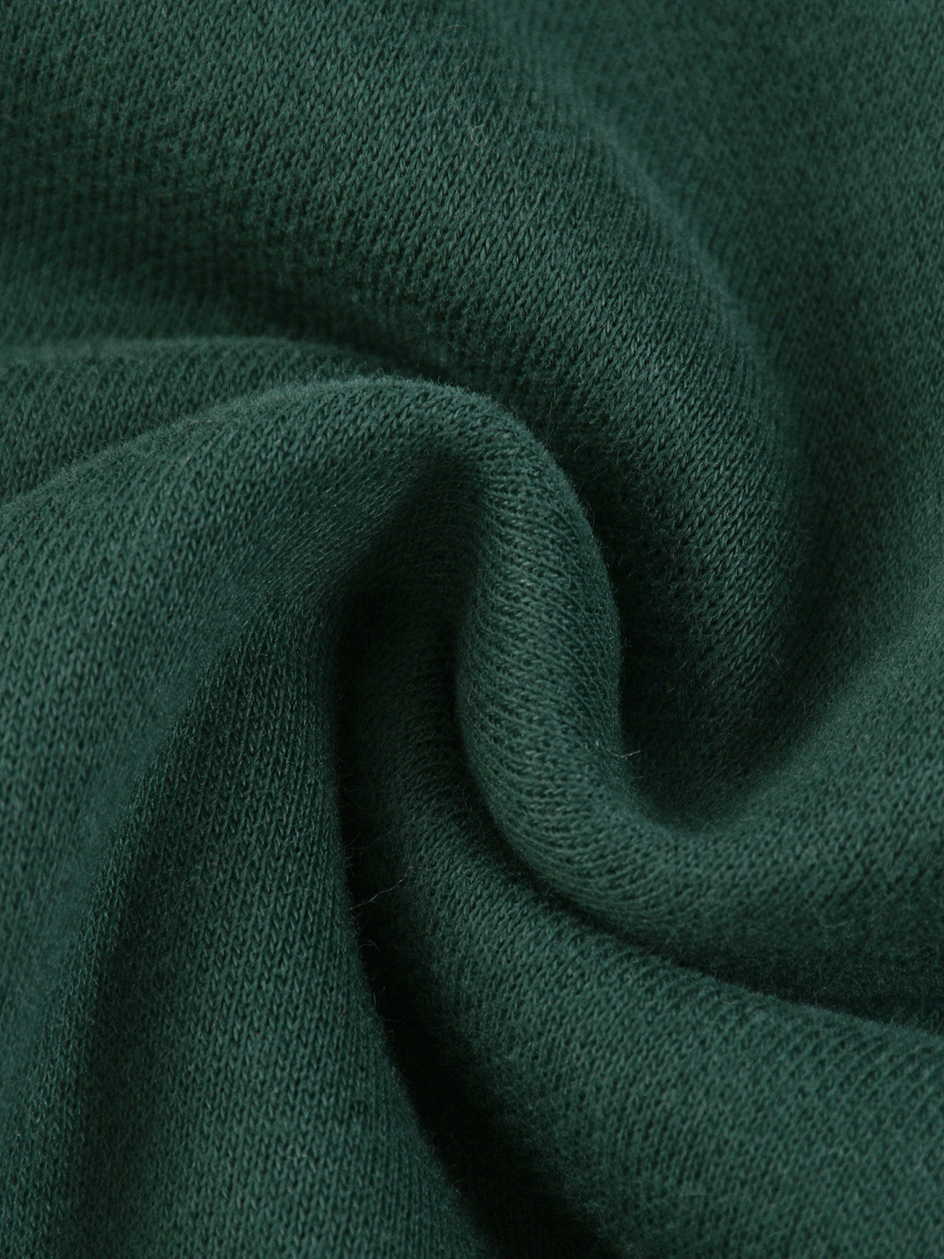 Close-up of dark green fabric with a textured pattern