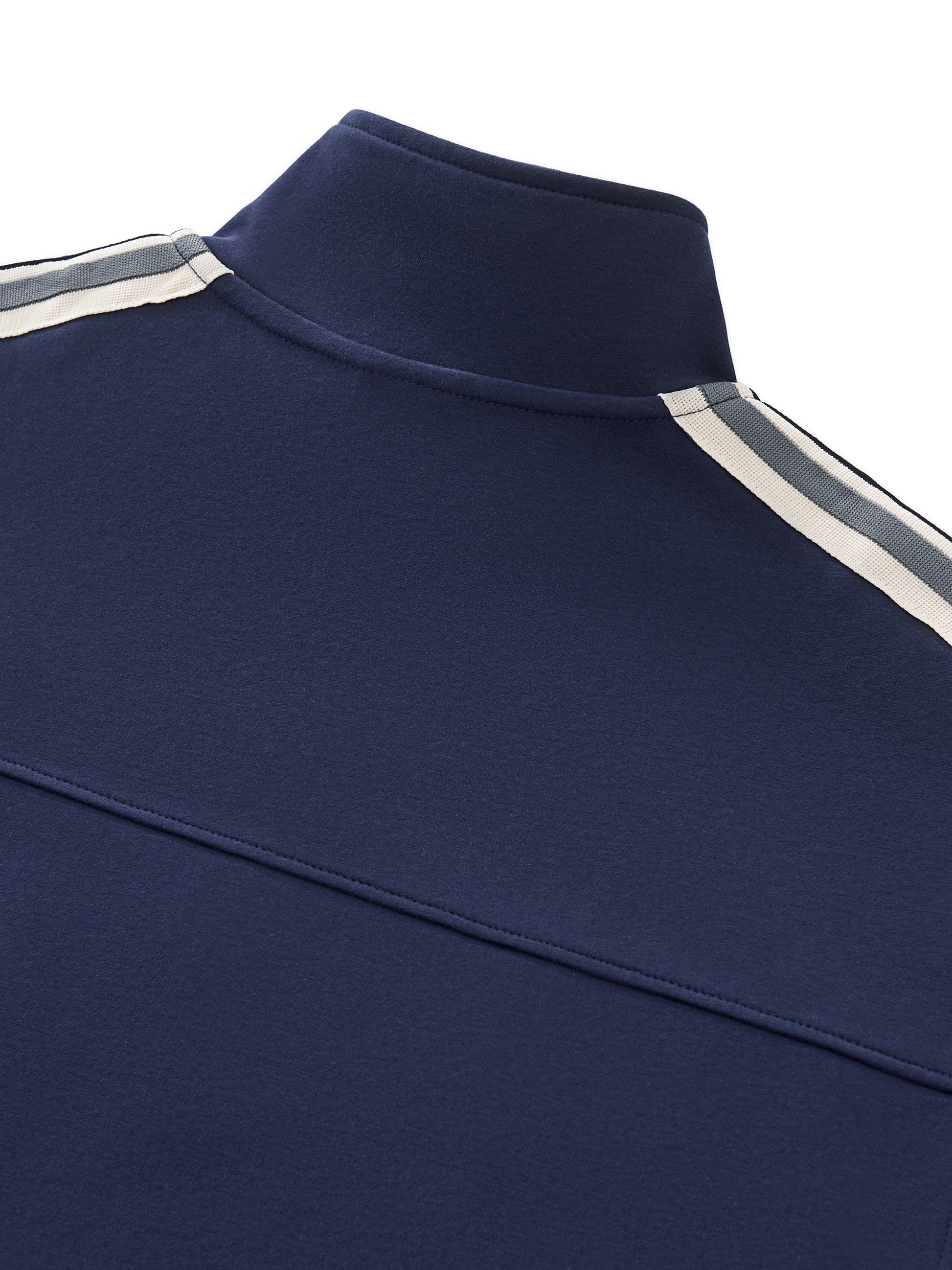 Close-up of a navy blue garment with white and gray stripes on a white background