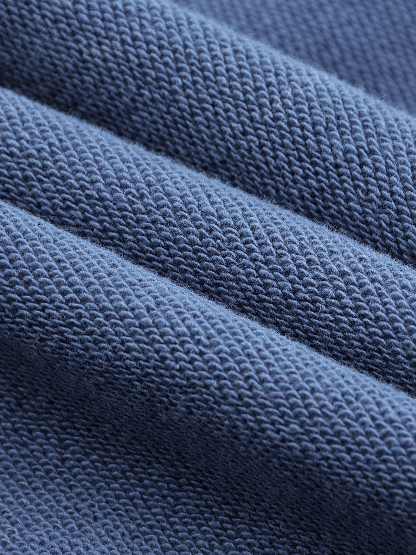 Close-up of blue textured fabric in folds