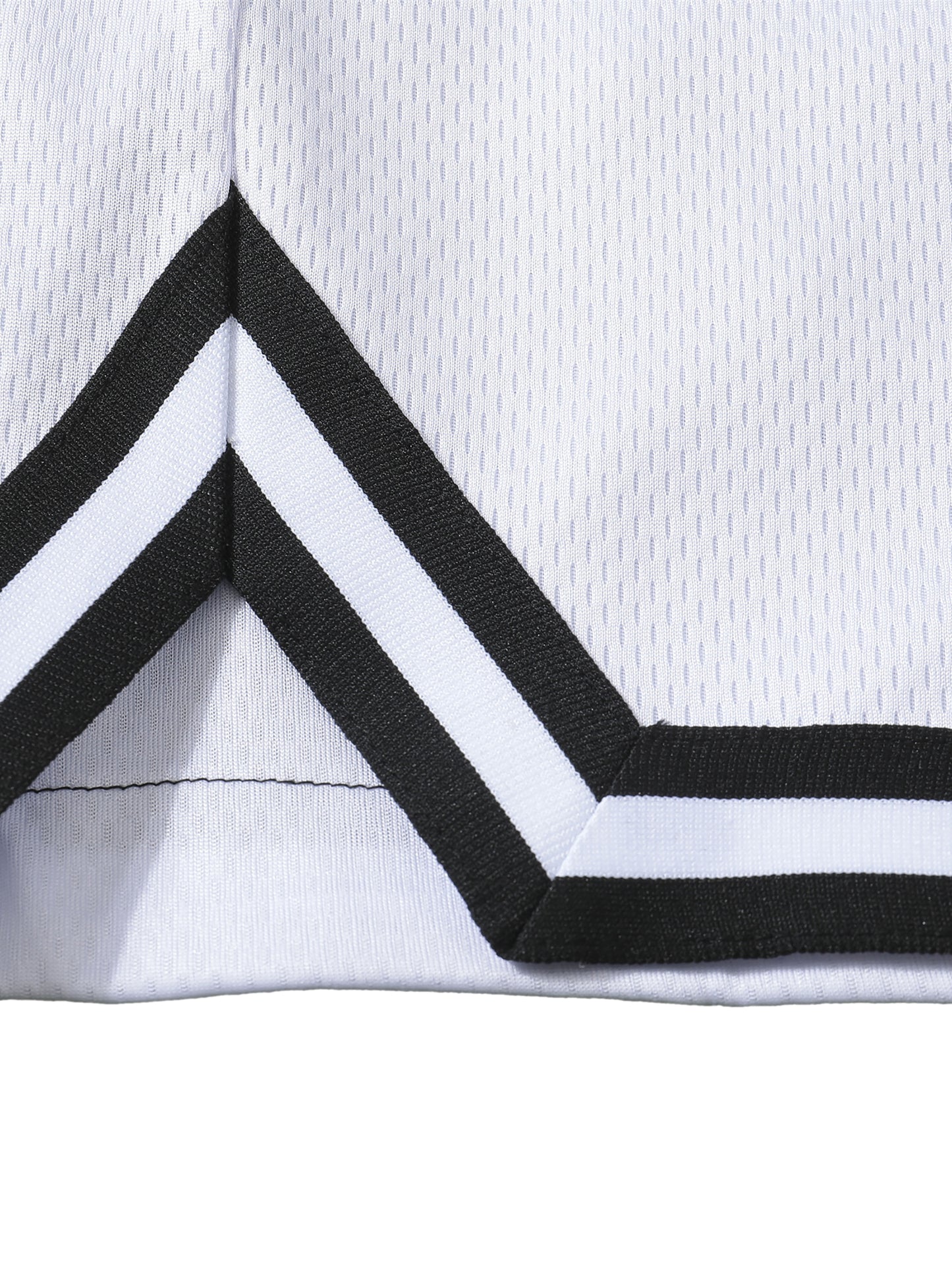 Close-up of a white basketball shorts with black and white striped trim on a white background