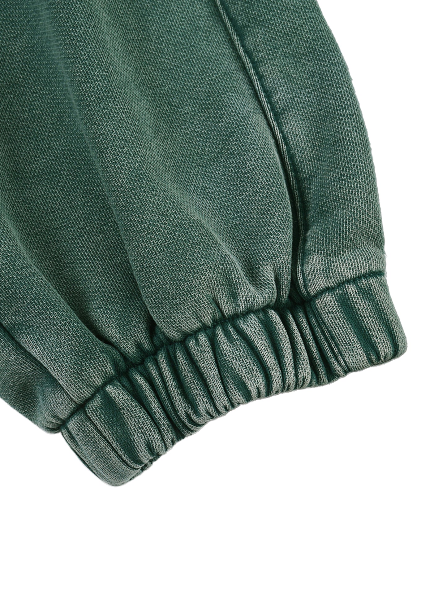 Green fabric with a textured pattern on a white background