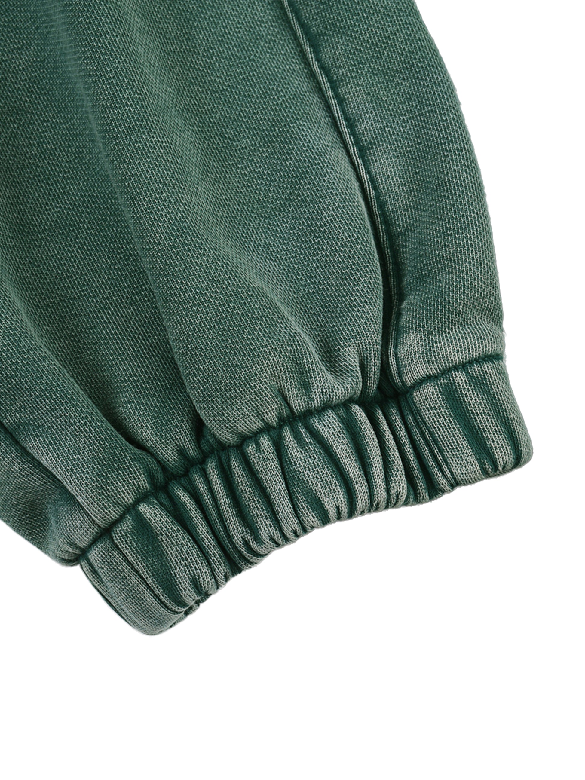Green fabric with a textured pattern on a white background