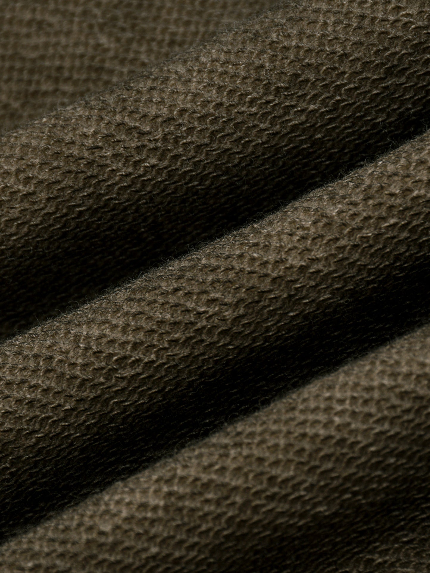 Close-up of brown fabric texture in a folded motion