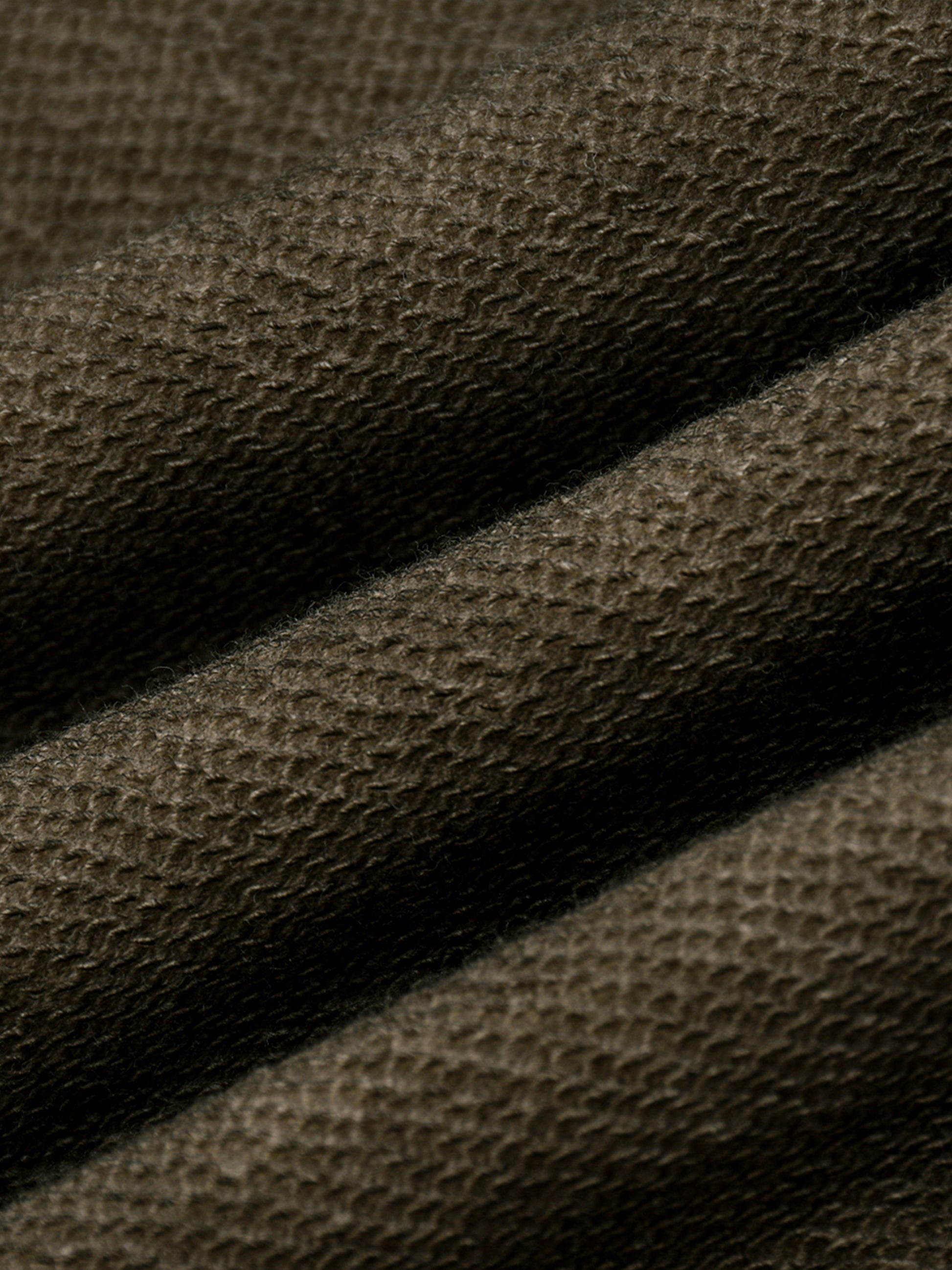 Close-up of brown fabric texture in a folded motion