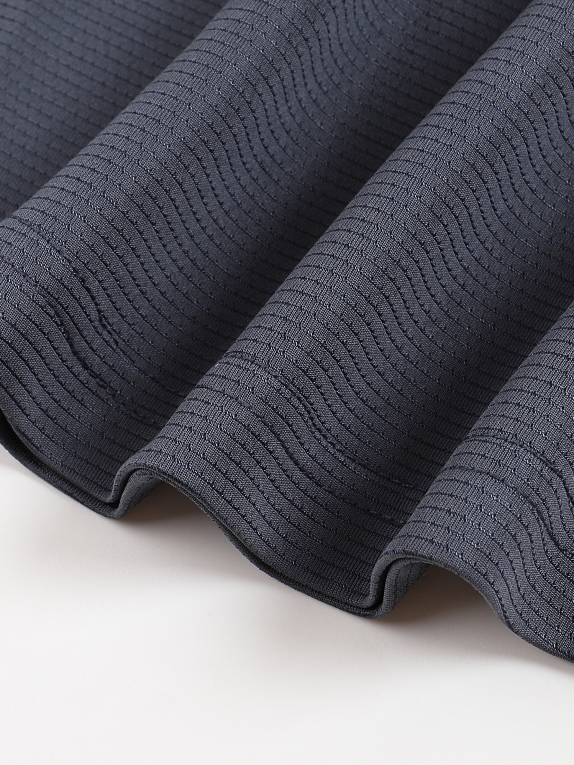 Close-up of dark gray textured fabric on a light background