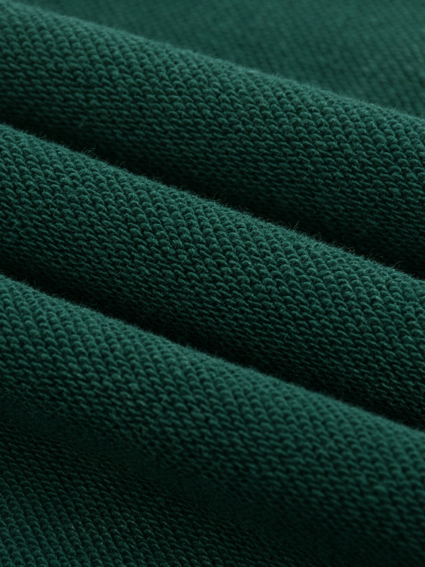 Close-up of dark green fabric texture