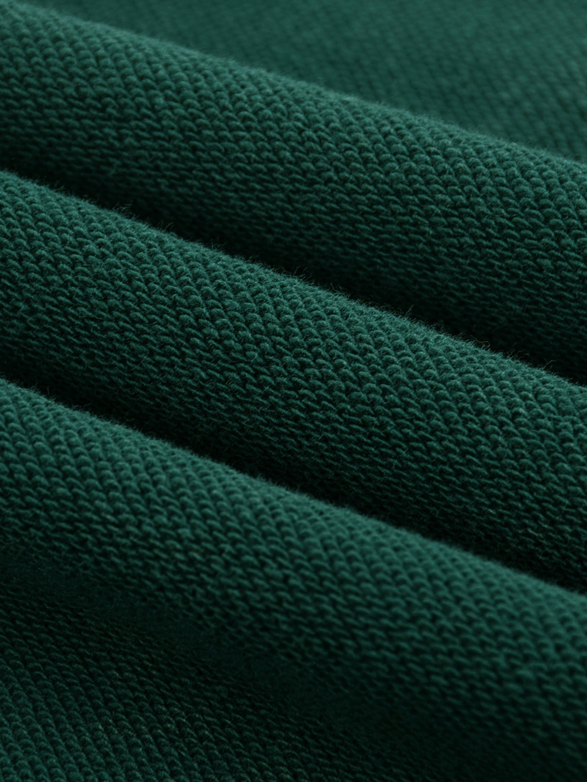 Close-up of dark green fabric texture