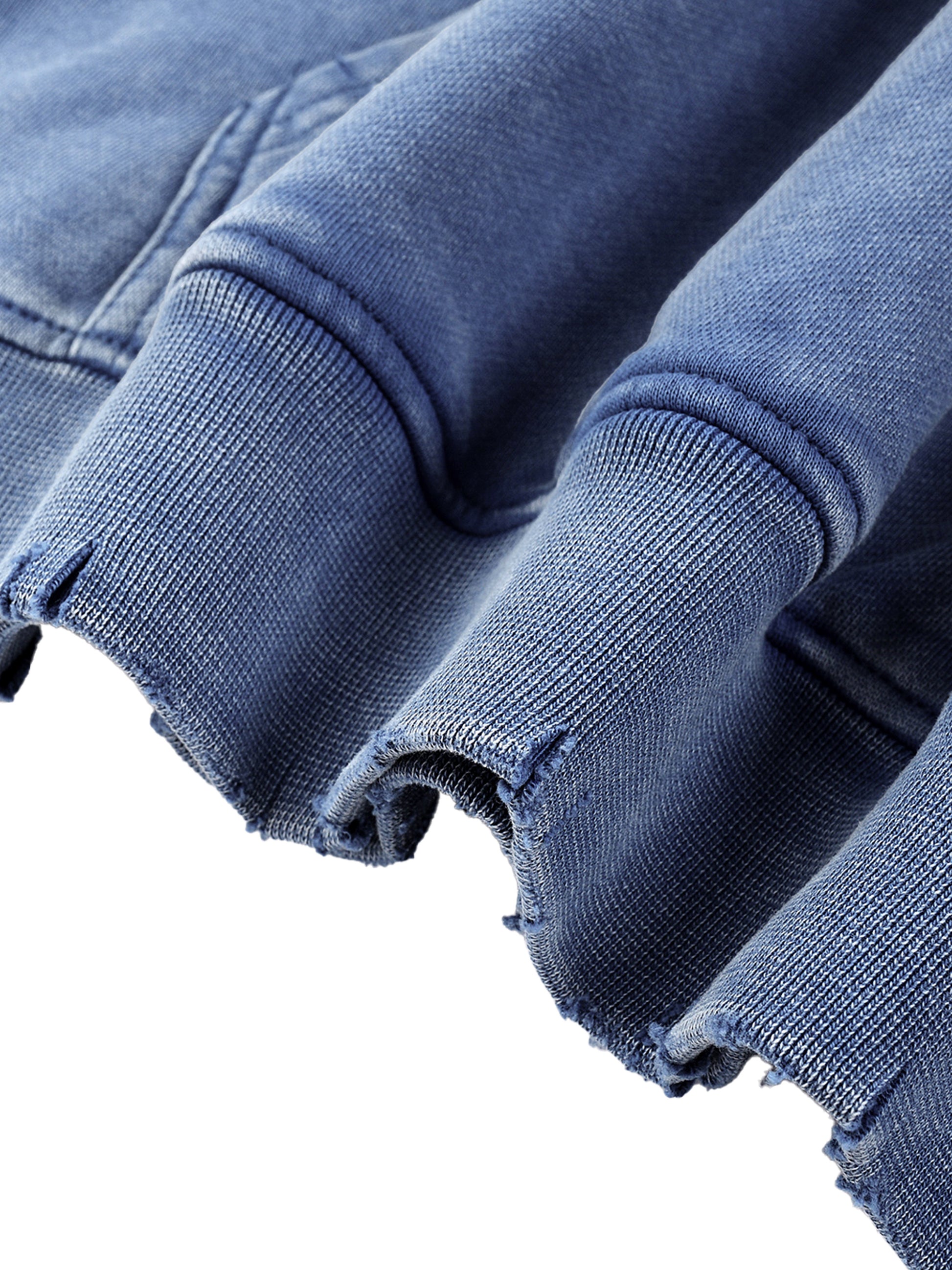 Close-up of faded blue fabric with a white background