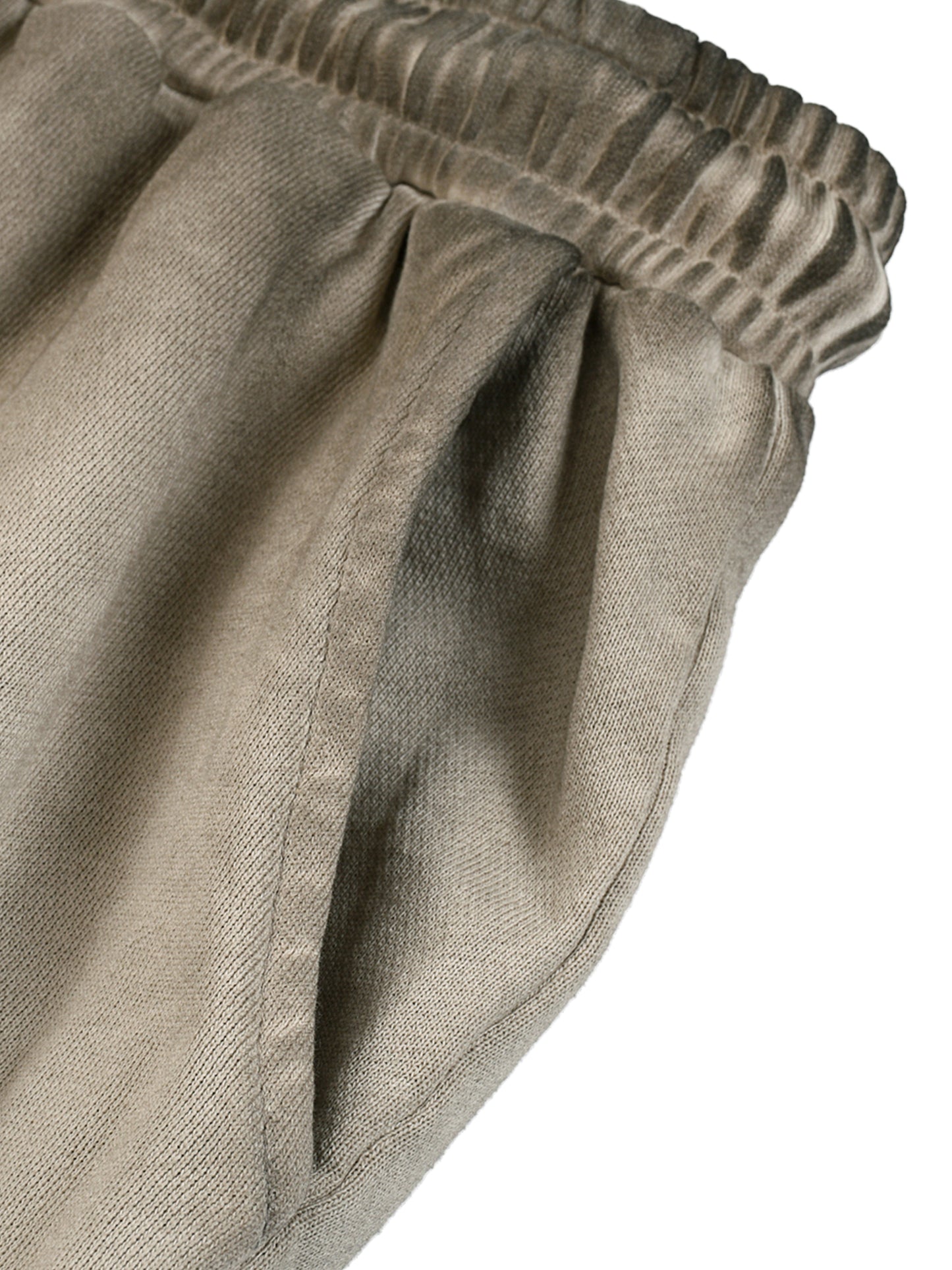 Close-up of beige pants with an elastic waistband on a white background