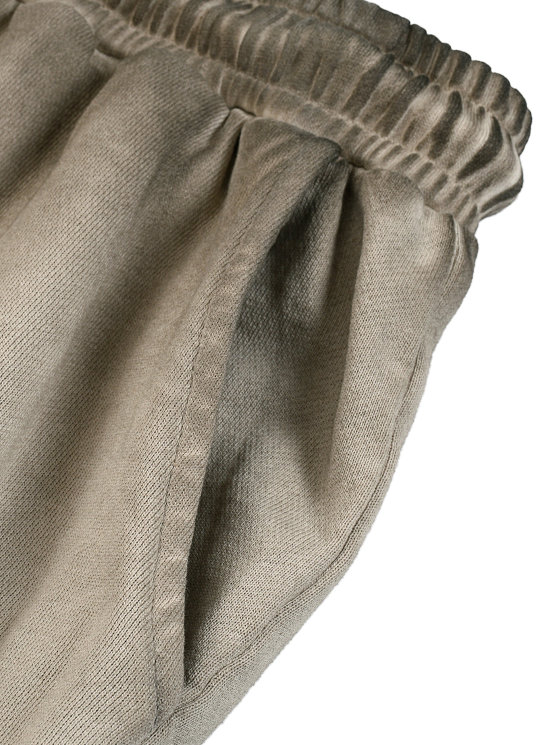 Close-up of beige pants with an elastic waistband on a white background