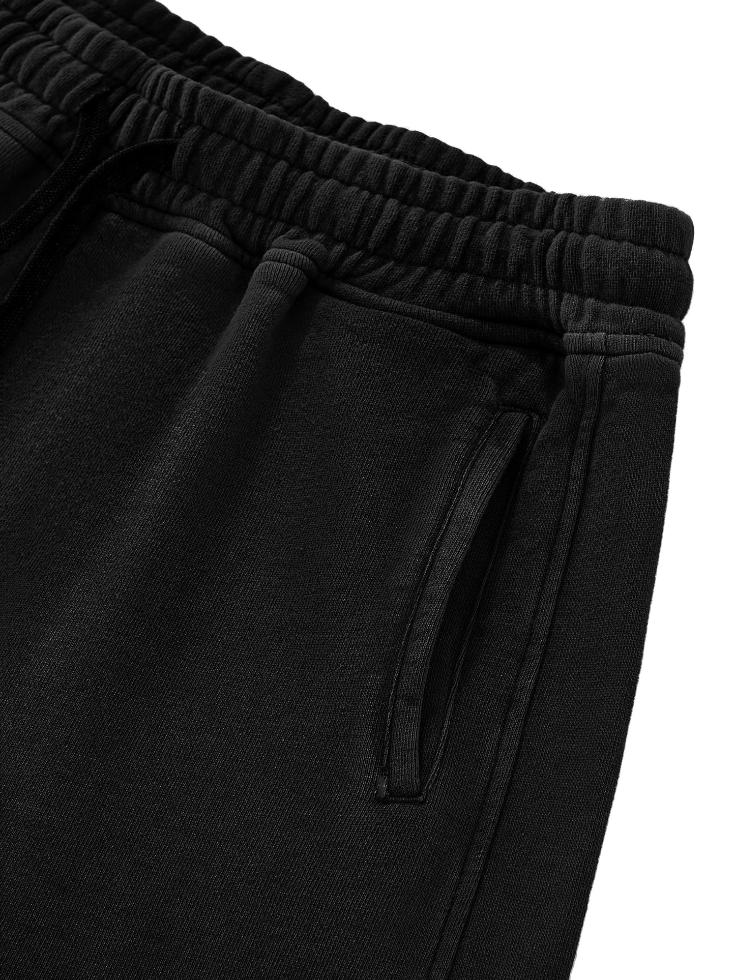 Close-up of black shorts with drawstring on a white background