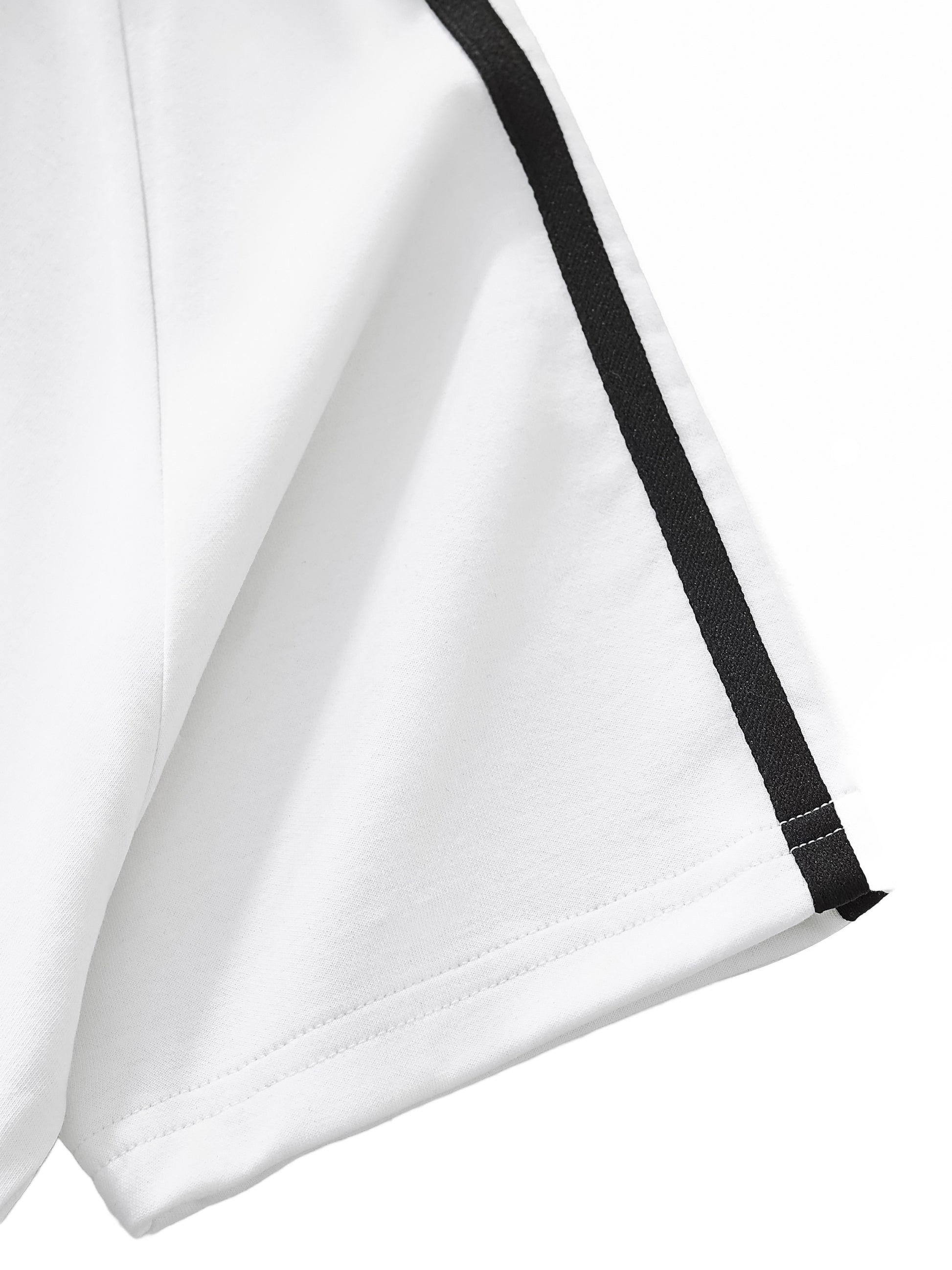 Close-up of a white garment with black trim on a white background