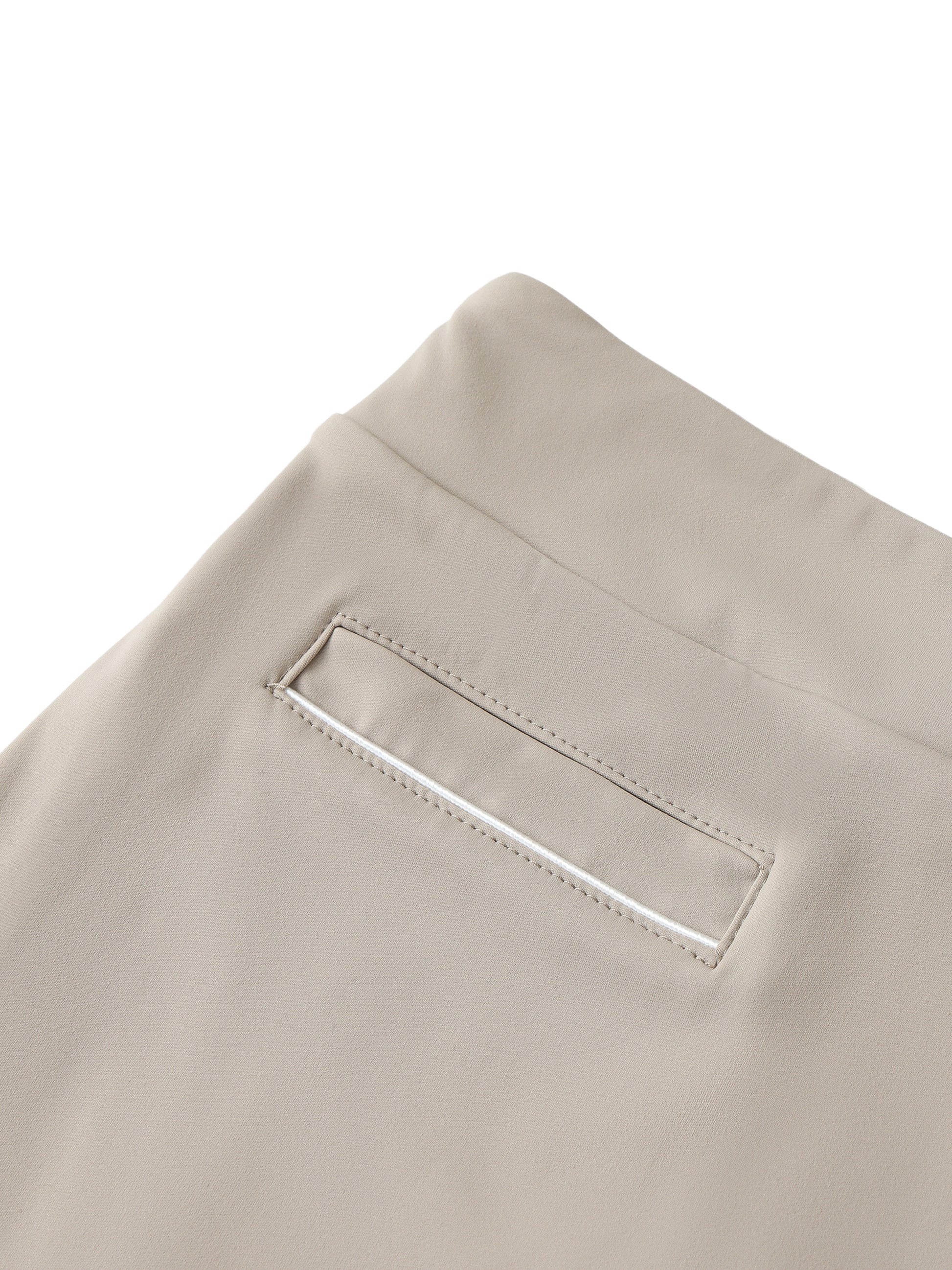 Close-up of beige skirt with a pocket detail on a white background