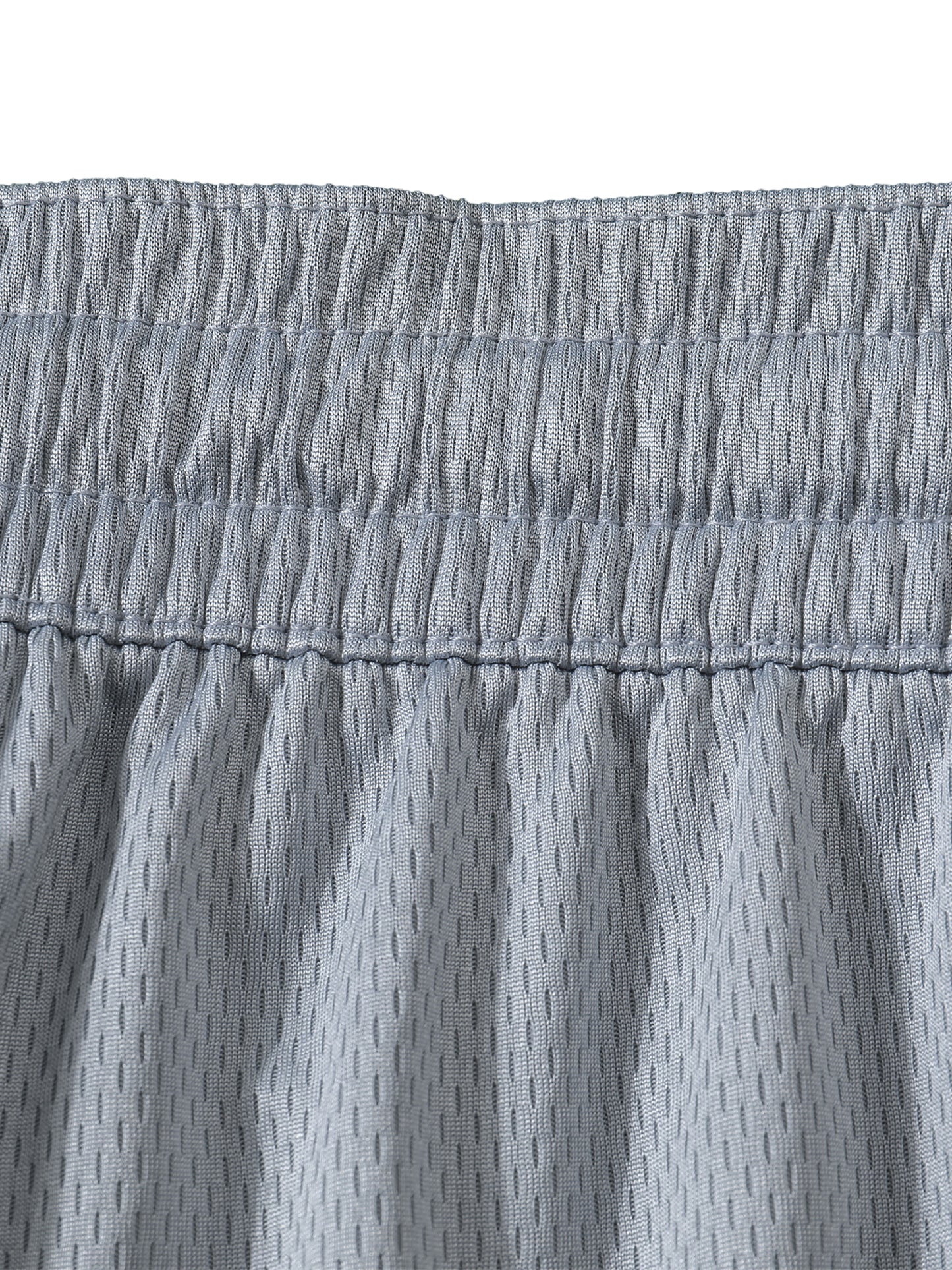 Close-up of gray shorts with a textured pattern on a white background