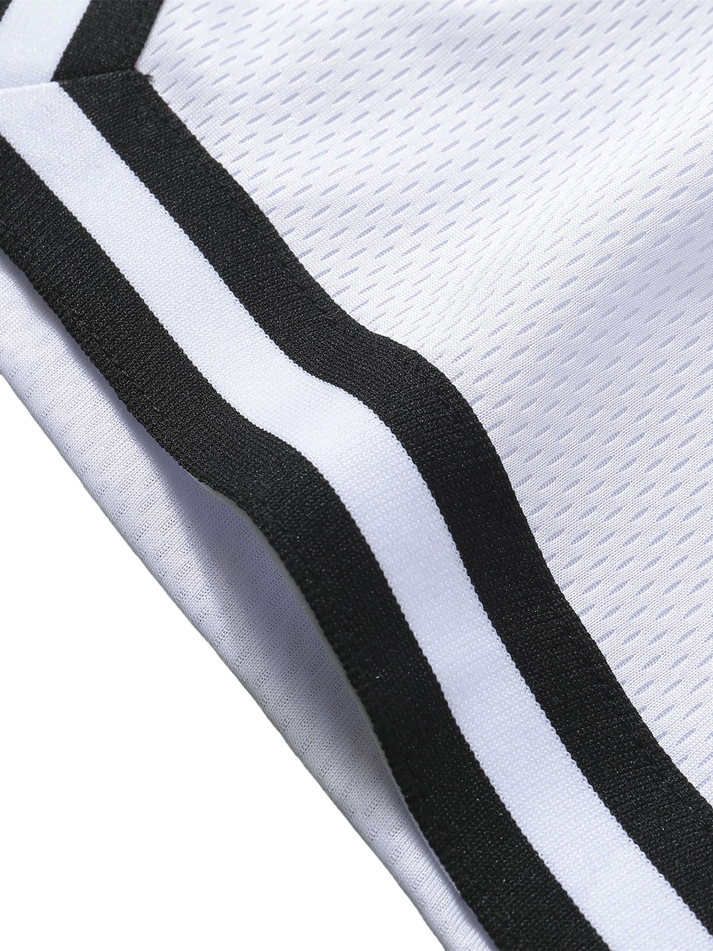 Close-up of a white basketball shorts with black stripes on a white background