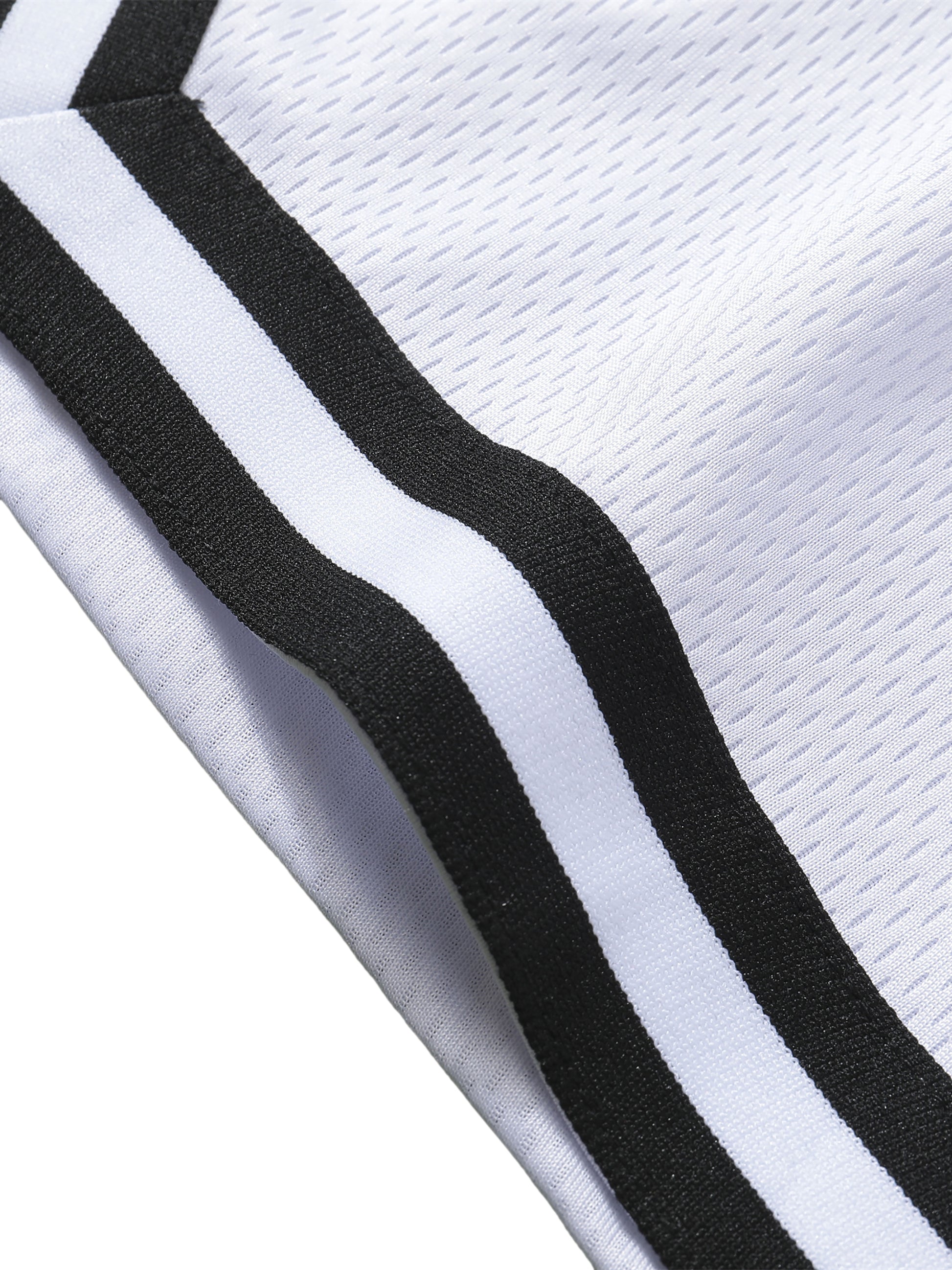 Close-up of a white basketball shorts with black stripes on a white background