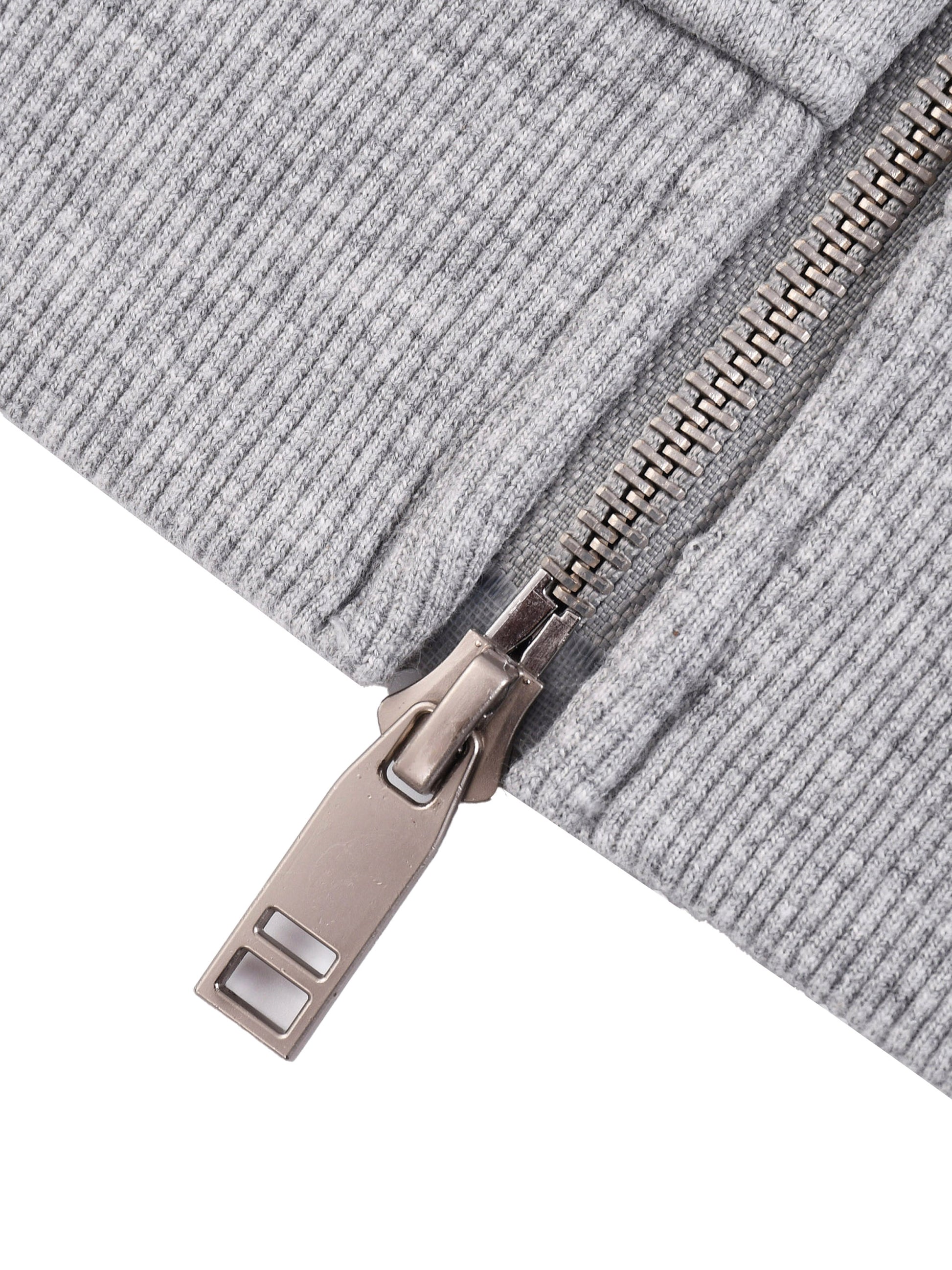 Close-up of a zipper on a gray textured fabric background