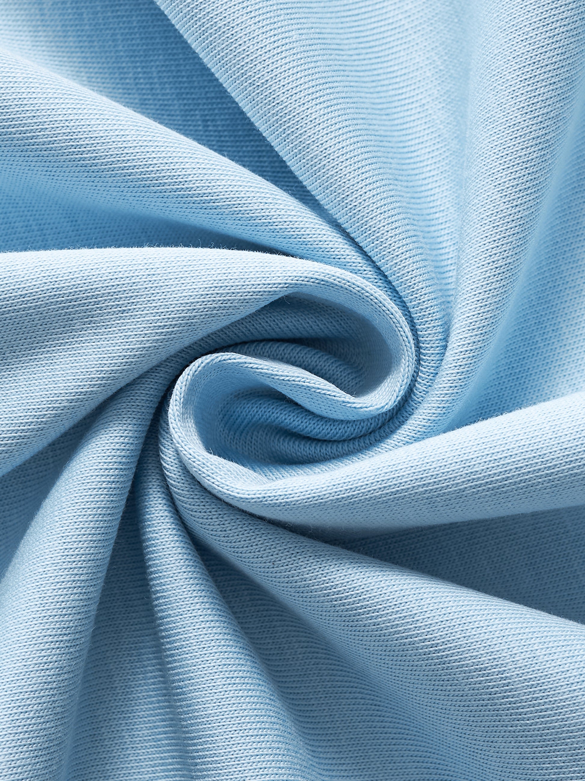 Close-up of light blue fabric with a swirl pattern