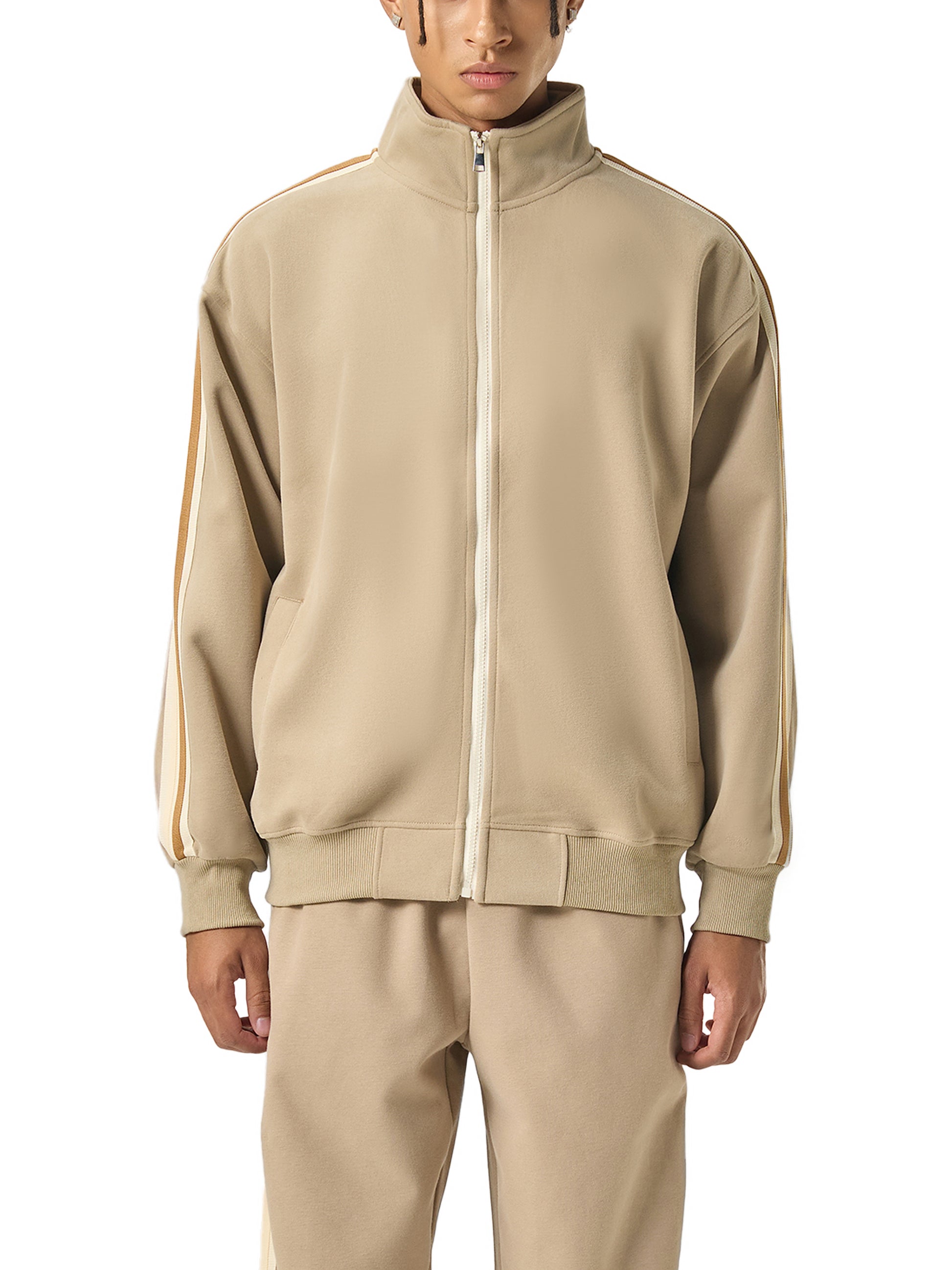 Beige tracksuit worn by a person on a white background