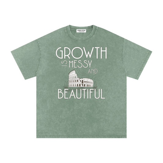 Front of green t-shirt with 'growth is messy and beautiful' text with a graphic image of the colosseum in front of a white background.