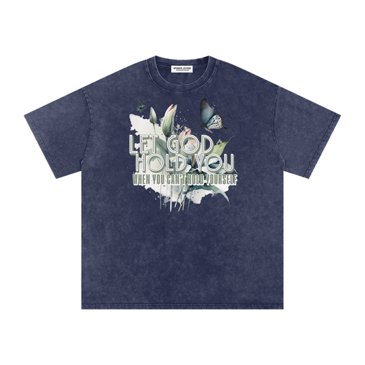 Navy t-shirt with nature-themed design and text that says "Let God Hold You, when you can't hold yourself" on a white background.