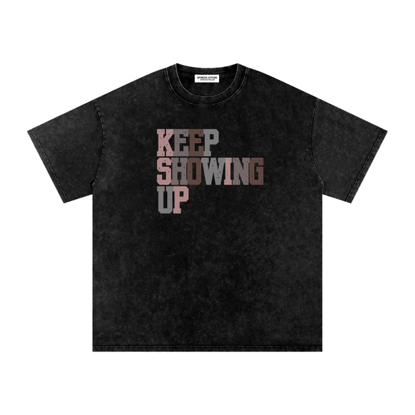 Front of black t-shirt with "keep showing up" text in the colors light pink, medium gray, mauve, and neutral brown in front of a white background.
