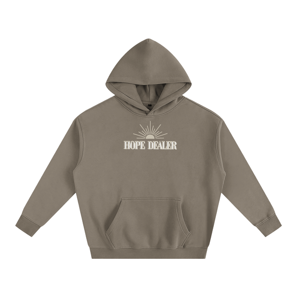 Brown/khaki hoodie with 'HOPE DEALER' text and sun graphic on a white background. Hope dealer text is tan and white and sun graphic is tan.