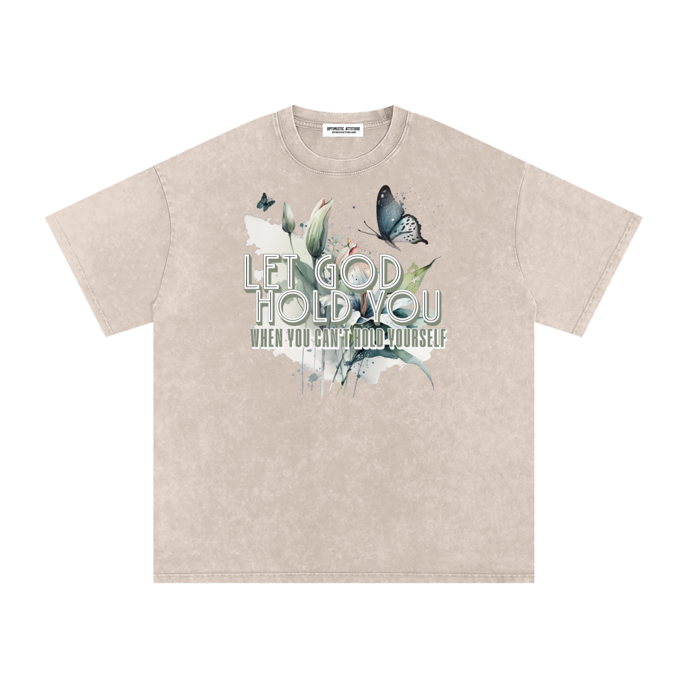 Cream t-shirt with nature-themed design and text that says "Let God Hold You, when you can't hold yourself" on a white background.