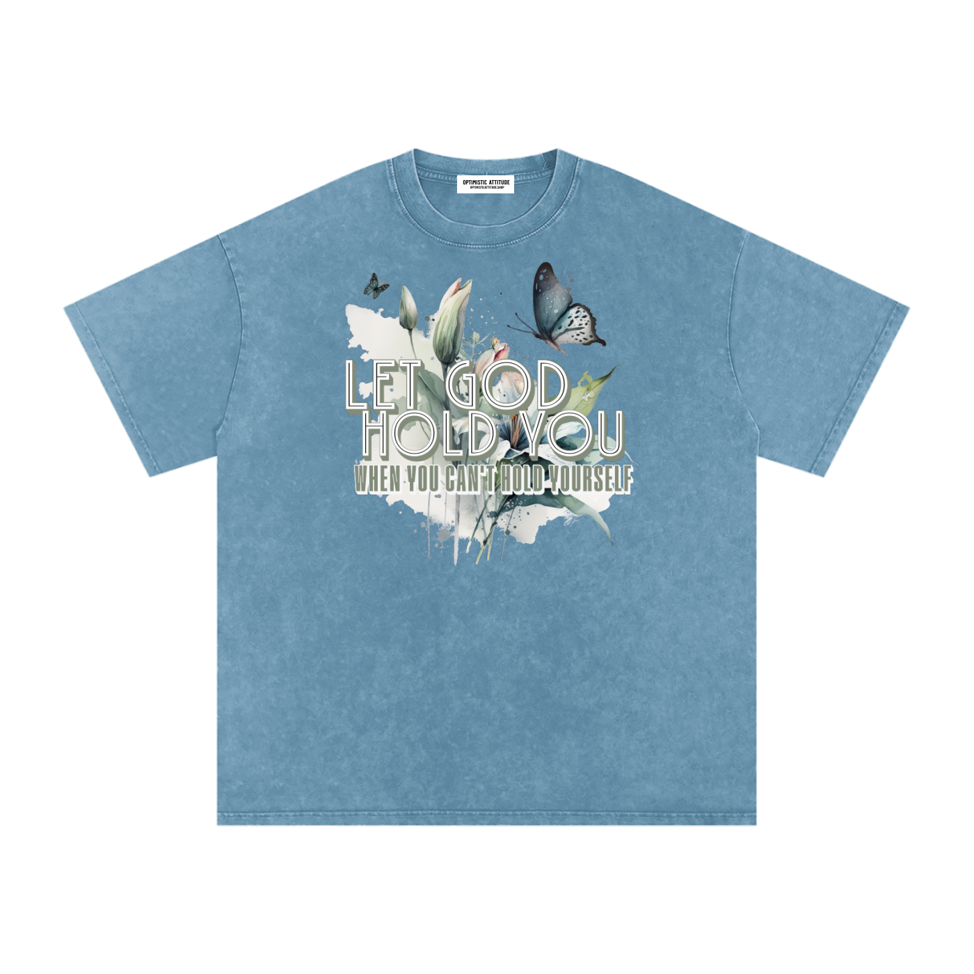 Blue t-shirt with nature-themed design and text that says "Let God Hold You, when  you can't hold yourself" on a white background.