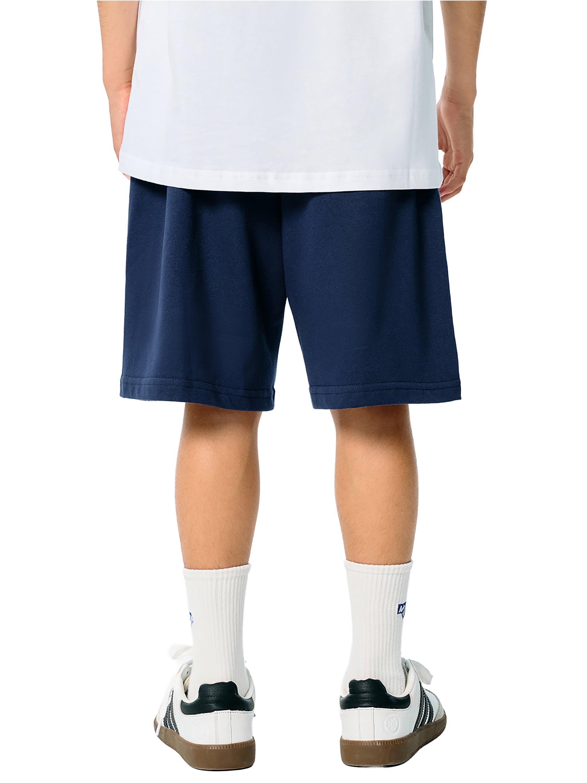 Person wearing navy shorts and white socks on a white background